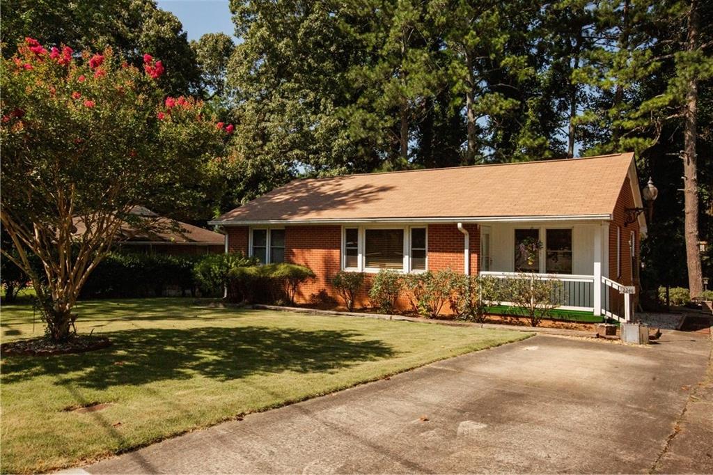 Charming 1950s Brick Ranch in Prime Smyrna Location! Welcome to this beautifully maintained 4-bedroom, 2-bath brick ranch, ideally located just minutes from The Battery, I-75, and I-285. Nestled in a quiet, established neighborhood with no HOA, this home offers timeless charm with modern updates. Step inside to find a spacious, light-filled layout featuring a large kitchen that opens to a cozy breakfast room and flows seamlessly into the adjoining dining room—perfect for everyday living and entertaining. The main level boasts two bedrooms with gorgeous hardwood floors and two with brand new carpet, all generously sized to suit your needs. The finished basement adds valuable flexible space—ideal for a media room, office, or playroom. Enjoy peace of mind with major system updates including a brand new roof, HVAC and hot water heater replaced in 2022, and a 10-year transferable HVAC warranty. Outside, relax on the peaceful back porch overlooking the beautifully landscaped yard, or take advantage of the oversized driveway with side-by-side parking. The home features an exterior light that was once one of the original street lights on the Marietta Square! This move-in ready home offers the perfect blend of location, space, and updates. Don't miss your chance to own a classic home in one of Smyrna’s most convenient and desirable areas!