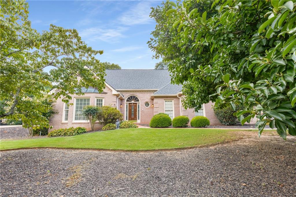 Nestled within the prestigious Polo Golf & Country Club community in Cumming, Georgia, this custom-built, 4-sided brick ranch on a full basement exudes timeless appeal. A majestic tulip tree greets you as you approach this meticulously maintained home, offered for the first time by its original owner and one of the initial residences in the Polo development. The expansive, level backyard is beautifully landscaped, presenting an ideal setting for a private pool oasis.
Experience the unparalleled convenience of this prime location, where the golf course is visible from the driveway, the community pool parking is across the street, and the tennis and pickleball courts are just around the corner.
Inside, discover site-finished hardwood floors and striking vaulted ceilings that enhance the open and airy ambiance. The kitchen, designed for seamless entertaining, offers ample space for gatherings. The oversized primary suite, situated on the main level, features a charming bay window and an elegant trey ceiling. The generously sized living room, anchored by a beautiful fireplace, flows effortlessly into the dining area.
The upper level boasts two spacious bedrooms, a full bathroom, and expandable attic space, perfect for creating an additional room to suit your needs. Storage abounds throughout the home, with numerous closets and several dedicated storage rooms. A dedicated workroom, equipped with an extra-wide exterior door, allows for convenient storage of a riding lawn mower.
The basement extends the living space, offering another comfortable gathering area complete with a fireplace. A large room currently utilized as an office provides the flexibility to serve as an additional bedroom, complemented by a full bathroom and a discreet storage area behind the door.
This cherished, custom-built home is an extraordinary opportunity, ready for a new owner to infuse their personal style and create lasting memories. Polo Golf & Country Club is a family-friendly private club in Cumming. The community offers a championship golf course, adult and family swim centers, a tennis center with 10 lighted courts, and a vibrant social calendar. The club also includes a practice facility with a driving range, putting green, and chipping area. To be a member of the club is an additional fee. Polo is in the highly sought after Forsyth County Schools and is convenient to shopping ang Georgia 400.