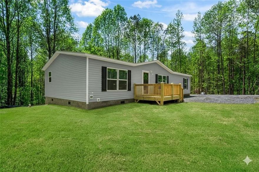 Just Built 2025 Home on Permanent Foundation!  Be the first to live in this just-built 2025 manufactured home, offering the perfect combination of modern style, space, and peaceful mountain living! Set on a permanent metal foundation with the title retired (loan-ready or great for cash buyers), this 1,568 sq ft, 3-bedroom, 2-bathroom home is located on a gently rolling lot just 10 minutes from vibrant Downtown Ellijay.  Step inside to find tall ceilings, quality finishes throughout, and a spacious open layout designed for comfortable living. The large living room features a stylish accent wall and ceiling fan, while the beautiful kitchen boasts stainless steel appliances, custom cabinetry, and a large center island. A cozy dining area flows easily from the kitchen-ideal for everyday meals or entertaining. The oversized primary suite includes an accent wall, a large walk-in closet, dual vanities, a soaking tub, and a separate stand-up shower. Two additional generously sized bedrooms and a second large bathroom provide ample space for family or guests.  Outside, enjoy both front and back decks, a nice yard with plenty of usable space, and a quiet, desirable area with paved road access. The property comes complete with new well and septic systems, high-speed internet, and excellent cell service. There's no HOA (just light covenants), and a shared driveway agreement is already in place.  This move-in ready home has everything you've been looking for-schedule your showing today before it's gone!