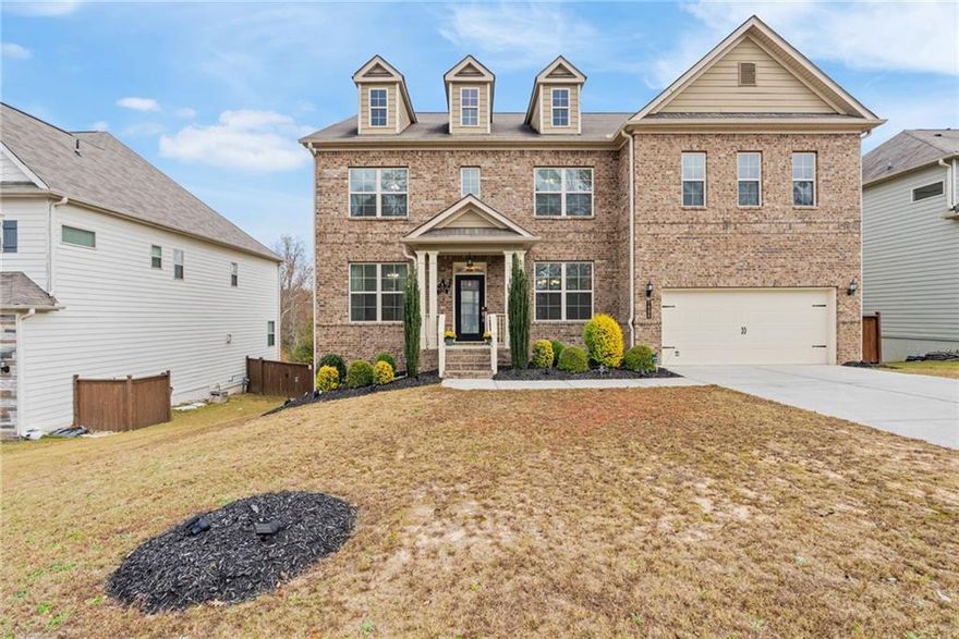 Welcome to a home that truly offers it all: 5 bedrooms, 4 baths, and over 4,200 sqft, perfectly situated in one of the area's most desirable neighborhoods.

This house is the LARGEST FLOOR PLAN in the community, and it’s designed for both grand entertaining and comfortable everyday living. The main level features gleaming HARDWOOD FLOORS and a bright, open-concept flow, centered around a CHEF-INSPIRED KITCHEN. It boasts a large center island, a sunlit breakfast area, a spacious pantry, and a dedicated butler's pantry for effortless hosting. The kitchen seamlessly connects to a cozy family room anchored by a gas fireplace. The formal dining room provides a dedicated space for entertaining, while the convenient guest suite with an en-suite bath can also serve as a versatile MAIN-LEVEL OFFICE.

Upstairs, the expansive owner's suite provides a luxurious private retreat. You’ll find a SPA-LIKE BATH and an OVERSIZED WALK-IN CLOSET, ensuring a peaceful start and end to your day. The three additional generously sized bedrooms are thoughtfully designed, two with a shared bath, and the third featuring its own private en-suite. A dedicated upstairs laundry room provides unmatched convenience.

The lower level offers both immediate entertainment and future potential. This partially finished space currently hosts a THEATER ROOM designed to seat up to ten people. The rest of the basement features over 1,500 SQFT OF UNTAPPED POTENTIAL, perfect for customizing your own home gym, game room, or versatile bonus space.

Outside, enjoy your private COVERED DECK, ideal for setting up your perfect grilling or relaxation spot, rain or shine. You'll also benefit from top-rated schools and exceptional neighborhood amenities.

AREA HIGHLIGHTS: This prime location is conveniently located within a 20-minute drive of the Cumming City Center, Historic Downtown Ball Ground, and the North Georgia Premium Outlets. The exciting new Coal Mountain Town Center, currently under development with shopping, dining, and entertainment, is just 10 minutes away. Plus, the beautiful North Georgia mountains and an expansive offering of wineries are only a scenic 45-minute drive.

Don't miss the opportunity to own this truly move-in ready home! Schedule your showing today.