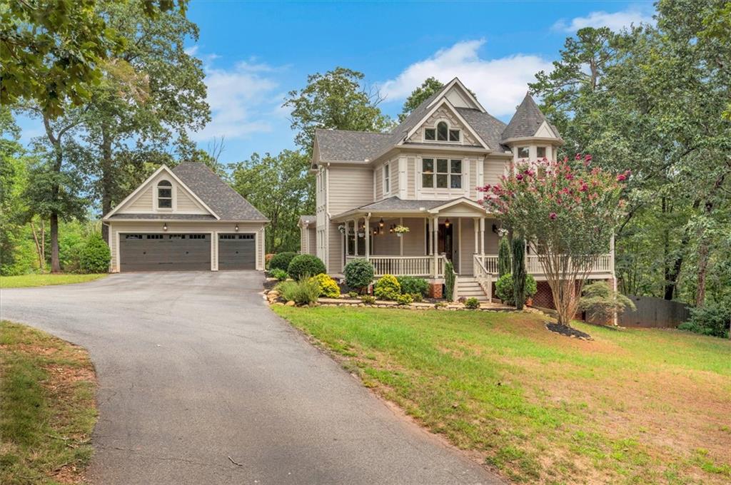 Nestled on 5.68 acres in Dawsonville, this stunning custom estate is a private sanctuary where exquisite craftsmanship and refined luxury greet you at every turn. Every detail—from the incredible outdoor swimming pool and spa to the soaring 10-foot ceilings and 8-foot solid mahogany doors to 10-inch baseboards, crown and shadow molding, rich red oak hardwood floors, and solid wood cabinetry—speaks to the exceptional quality and thoughtful design woven throughout. The main level unfolds with an inviting wrap-around front porch, a grand foyer, a gourmet chef’s kitchen with a cozy fireplace and walk-in pantry, and a banquet-sized dining room that transitions into a luminous family room anchored by yet another fireplace. You’ll also discover a spacious home office and a practical mud room that perfectly balance elegance and functionality. Upstairs, a magnificent owner’s suite with a fireplace and a luxurious bath awaits alongside generously sized secondary bedrooms with upgraded bathrooms, plus a versatile third-floor bonus space that can flex as a bedroom, media room, or playroom. The fully finished terrace level functions like an in-law suite—complete with a full kitchen, bar, media and games areas, a full bath, and a bedroom—ideal for guests or multigenerational living. Outside, embrace outdoor living on a generous deck that overlooks the property, and enjoy resort-style relaxation with a gorgeous saltwater pool featuring a hot tub, waterfall, and cabana. Additional highlights include a three-car garage with EV charger and potential guest suite or office above, a large electric-equipped pole barn, secure gated entry, a dog run, and many more refined touches. This one-of-a-kind estate offers unmatched privacy, versatility, and craftsmanship—a rare find in Dawsonville. Welcome home!