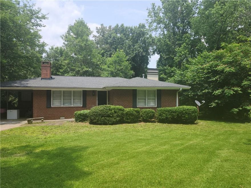 This delightful ranch-style residence offers classic charm with a welcoming front yard and a location just minutes from Rome’s popular shopping and dining spots. Inside, gleaming hardwood floors lead you through a comfortable living space anchored by a cozy fireplace—perfect for relaxing evenings. The kitchen features abundant cabinet storage and a layout ideal for both everyday use and entertaining. Each bedroom provides a peaceful retreat with natural light and inviting comfort. Step outside to a private backyard, a serene space surrounded by mature greenery, ideal for outdoor dining, gardening, or quiet mornings with a cup of coffee. A perfect blend of convenience and comfort in a tranquil setting.