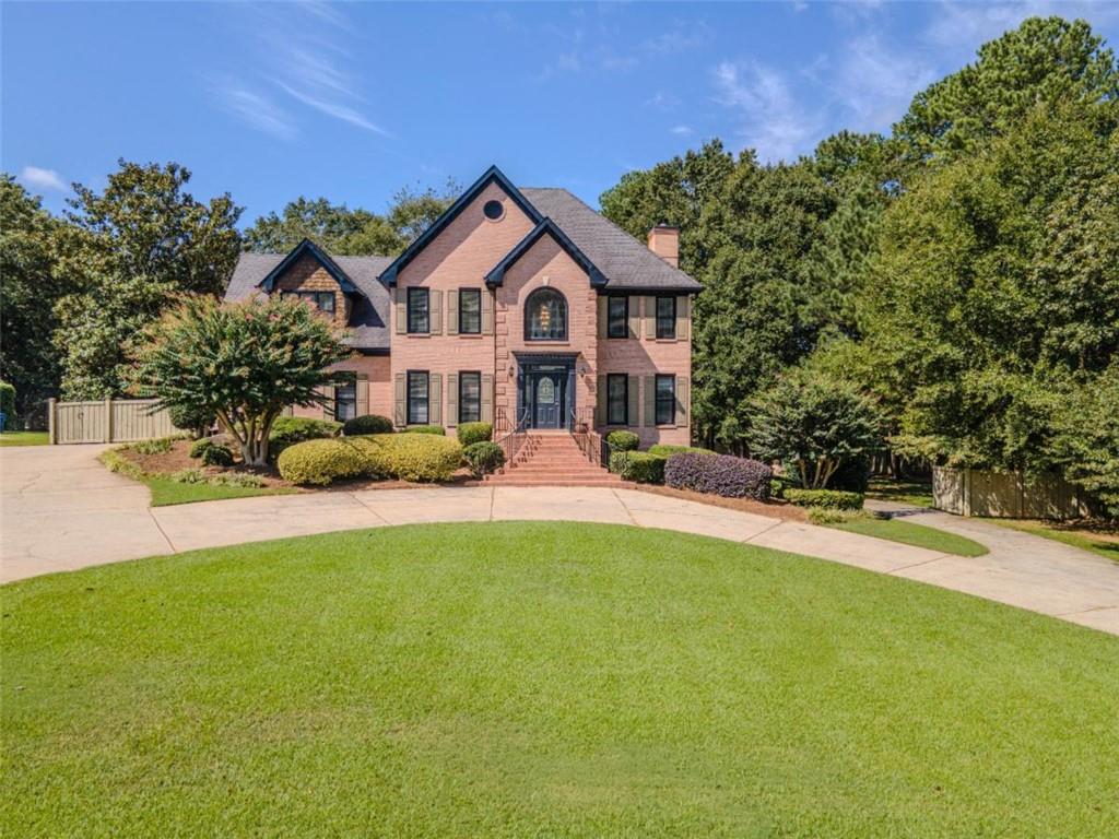 Step into elegance in the sought-after Saint Ives community of Winder. This stately four sided brick home welcomes you with timeless curb appeal and a grand circular drive, setting the stage for the spacious and versatile living found inside. From the moment you enter, custom details make an impression-coffered ceilings in the family room, refinished hardwood floors throughout, and a striking wood backsplash accenting the kitchen. The main kitchen features abundant cabinetry, a large island, and granite counters, perfect for both everyday living and entertaining. Upstairs, luxurious touches continue with spa-like retreats in both the primary and secondary suites, each offering Jacuzzi tubs designed for ultimate relaxation. Dual fireplaces-one in the main living area and another in the finished basement-bring warmth and charm to every level of the home. The finished basement is a true highlight, complete with its own kitchen, laundry hookup, wood plank tile flooring, and generous living space. Whether envisioned as private guest quarters, a home office, recreational retreat, or income-producing potential, this level offers flexibility to suit a variety of lifestyles. Set on a large, flat lot with a fenced backyard, the property balances open green space with wooded privacy, creating a peaceful setting for outdoor enjoyment. Whether entertaining on the deck, cozying up by the fire, or unwinding in a Jacuzzi tub, this home blends comfort, function, and style in one of Barrow County's most desirable swim/tennis neighborhoods.