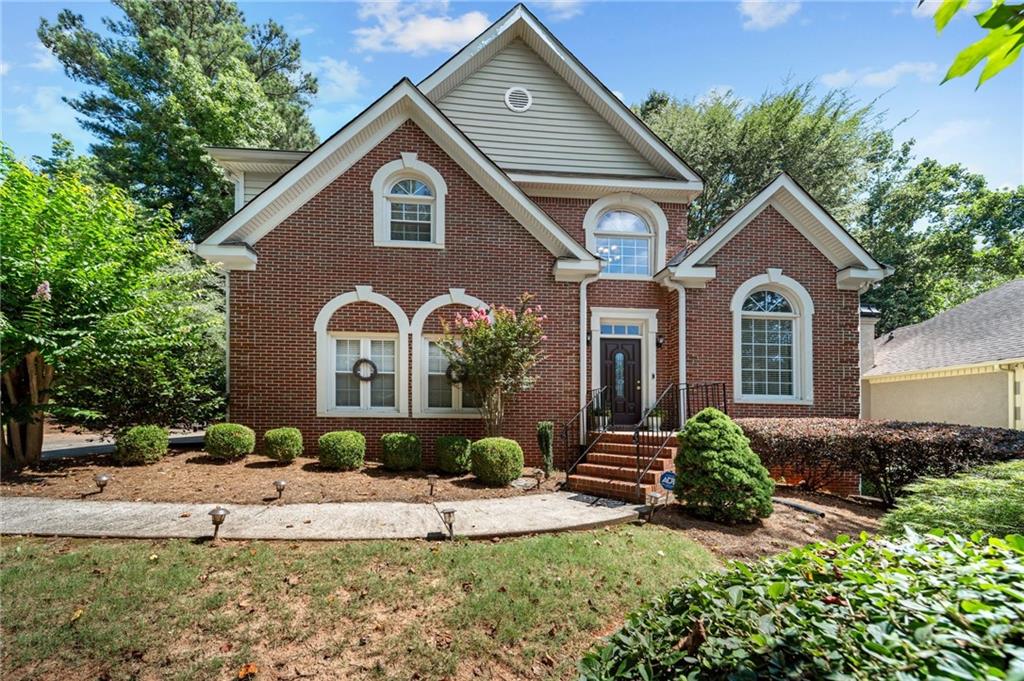 This stunning brick-front beauty in Marietta’s most desirable locations and in Hillgrove HS checks all the boxes! This well-maintained home offers a perfect blend of classic charm and modern comfort, beginning with a soaring two-story foyer that opens into the formal living room flooded with natural light—an ideal space for gatherings and entertaining. The adjoining formal dining room sets the stage for elegant holiday meals, while luxury vinyl plank flooring flows seamlessly throughout the main level, adding warmth and durability. The chef’s kitchen features granite countertops, stainless steel appliances, ample cabinetry, and a window above the sink for added light and views. Just off the kitchen is a spacious casual living area anchored by a cozy brick fireplace and framed by a wall of windows overlooking your private backyard oasis. Upstairs, unwind in your oversized primary suite with trey ceilings and a generous en-suite bath that includes dual vanities, a soaking tub, and a separate shower. Three large secondary bedrooms offer flexibility for guest space, a home office, or kids’ rooms. But the real bonus is downstairs! The finished basement is a true entertainer’s dream, complete with a home theater with stadium seating, a custom bar, and space for arcade games or a pool table—perfect for game nights and weekend fun. Enjoy Georgia summer bbq's on your back deck while kids or pets play in the large, level backyard. Community amenities include a swimming pool, tennis courts, playground, and walking trails to Kennesaw Mountain. Located across from Cheatham Hill Elementary and just minutes to Marietta Square, Publix, Kroger, Target, and Home Depot—everything you need is right at your doorstep.