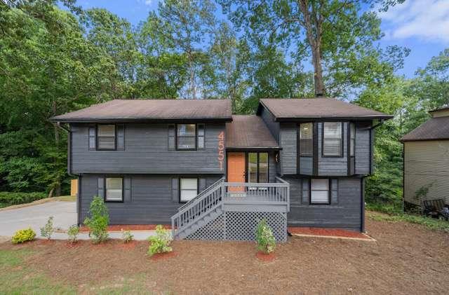 Gorgeously Renovated Split-Level Home with Entertainer's Upgrades and Chic Aesthetic! Idyllically nestled just moments from schools and grocery stores, this residence offers the best of all worlds with both a quiet community and a completely reimagined aesthetic. Fresh exterior paint and tidy landscaping add to the unparalleled curb appeal, while the backdrop of mature trees add to the established appearance. Venture indoors to discover NEW neutral paint, NEW luxury vinyl plank floors, NEW light fixtures, an openly flowing layout, and a size-able living room for easy entertaining. Fabulously updated for contemporary needs, the gourmet kitchen dazzles with NEW stainless-steel appliances, NEW granite countertops, NEW cabinetry, gas stove, dishwasher, built-in microwave, island, and an adjoining dining area. Oversized to satisfy the most discerning desires, the owner's suite impresses with two separate closets and a stunning en suite boasting a glamorous soaking tub and custom rain shower. Two extra bedrooms and a full bathroom finish out the main-level, while the lower-level enjoys a large bedroom with private outdoor entry, full bathroom, secondary living area, and a flex room. Other considerations include an attached one-car garage, laundry area, fireplace, two balconies, 15-minutes to Downtown Atlanta, close to shopping, restaurants, parks, and entertainment, and more! Come see today, and get all the advantages of this beautifully renovated home!