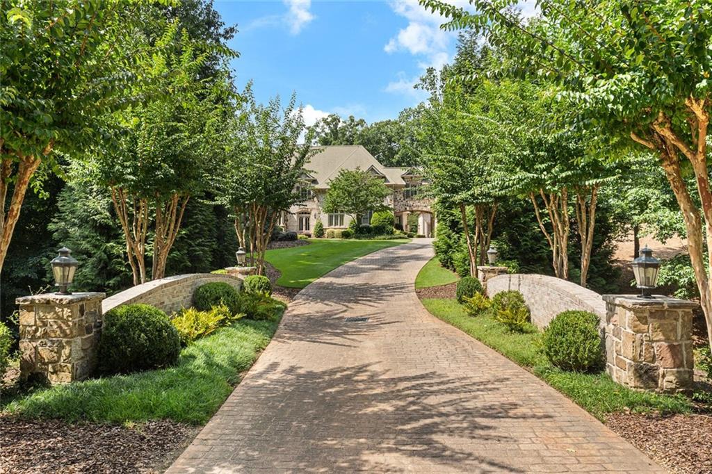 Artfully designed masterpiece situated on over 2 acres in an exclusive gated enclave across from Berkeley Lake. Stunning architecture with a full range of modern conveniences and unsurpassed outdoor living features providing a private oasis for year round family enjoyment. Luxurious, yet warm and welcoming, this exquisite residence will delight even the most discriminating buyer. Saltwater PebbleTech pool & spa. Outdoor kitchen with pizza oven and full range of appliances and expansive serving area. Porte-cochère with motor court. Resort style living right at home! Inside special features include a handsome wood paneled study with a fireplace, providing the perfect backdrop for working from home. The elegant dining room is perfect for entertaining a crowd. The gourmet kitchen is a chef's dream with top of the appliances including range and Subzero fridge. The luxurious primary suite is tucked away on the main level, complete with a fireplace and a dreamy sitting room overlooking the pool and landscaped gardens. Four en suite bedrooms upstairs, with cozy reading nooks throughout the main hallway, perfect for studying at home. The masterfully designed terrace level includes a family room, game room, exquisite bar, wine cellar, home theater, gym, au pair/in-law suite with full kitchen, and more. Wood burning outdoor fireplace. Putting green. In-ground trampoline. Control 4 home automation and security cameras. A truly remarkable and one of a kind property. Sale includes Lot 5 next door providing 2+ additional acres for a total of nearly 5 acres.