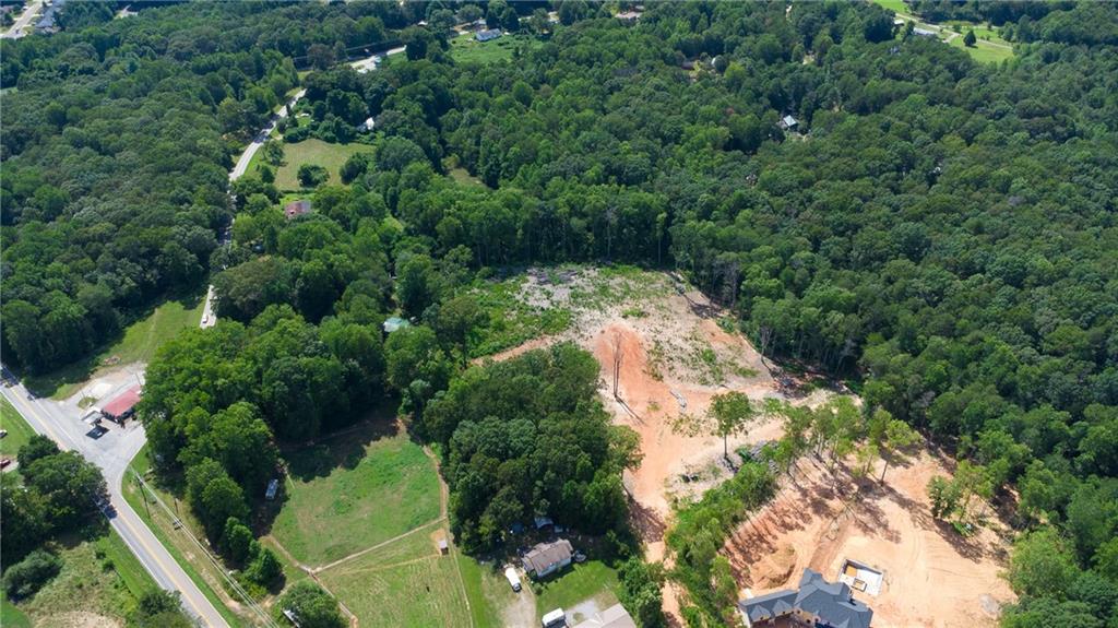 Stunning 11+ Acre Property in the Heart of Mill Creek – Ready for Your Dream Build
This beautiful 11.17-acre tract offers a rare opportunity for a builder, developer, or private buyer to create something truly special. Whether you're envisioning multiple homes or a private family compound, this land offers the flexibility and setting to make it happen.
Tucked away in the peaceful Mill Creek area between Dawsonville and Dahlonega, the property features a long dirt driveway that winds deep into the acreage, creating a private, secluded retreat set far back from the road. Much of the brush and trees have already been cleared, offering a head start on development and showcasing the property's natural topography.
A gentle spring meanders through the northern section of the land, enhancing the property's tranquil atmosphere and adding to its appeal for nature lovers or those dreaming of a serene homestead.
With elevated ridges offering potential home sites and a luxury home being built on adjacent land, this land is perfectly positioned for upscale development or a private luxury residence. Whether you build one breathtaking home perched on the ridge or several thoughtfully placed houses, this property is ready to bring your vision to life.