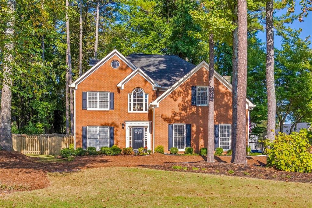 Discover the perfect family haven in a highly sought-after Marietta location! Meticulously maintained with updates throughout, this elegant 4 bed / 2.5 bath brick-front home is nestled on a corner lot in a quiet cul-de-sac within the Woodington neighborhood. Step inside to an inviting two-story foyer that opens to a formal sitting room and dining room, ideal for hosting and entertaining. The beautifully renovated kitchen serves as the heart of the home, showcasing quartz countertops, stainless steel appliances including a brand-new dishwasher and microwave, a spacious island with breakfast bar seating, Rev-A-Shelf pull-out shelving, under-cabinet lighting, and an open view into the fireside living room with a cozy gas log fireplace. The main level is filled with plenty of natural light, highlighting thoughtful updates such as engineered wood flooring, a newly refreshed powder room, and modernized stairs with updated balusters. Upstairs, the primary suite features tray ceilings, a large walk-in closet, and a gorgeous en-suite bath renovated in 2020 with a marble double vanity, shiplap accent wall, frameless glass shower, and a freestanding soaking tub. Three spacious secondary bedrooms share an updated hall bath, while the third level offers endless possibilities for an office, playroom, or bonus room. This home has been meticulously maintained with countless upgrades, including newer carpet, all new cordless blinds, upgraded baseboards, fresh interior paint, new hardware throughout, smoothed ceilings, and higher-profile toilets in every bath. Major systems have been updated as well with two 2021 HVAC units and smart thermostats, a newer water heater, 2021 PVC sewer line, and 2024 gutters, giving you peace of mind for years to come. Outside, enjoy the expansive back patio overlooking a beautifully landscaped and fenced backyard, perfect for entertaining, grilling, or simply relaxing by the fire pit. Additional highlights include a storage shed, a newer driveway with extra parking pad, and updated garage doors. Lovingly maintained by the original owners, this move-in ready home combines timeless design, thoughtful updates, and modern comfort in an unbeatable location.