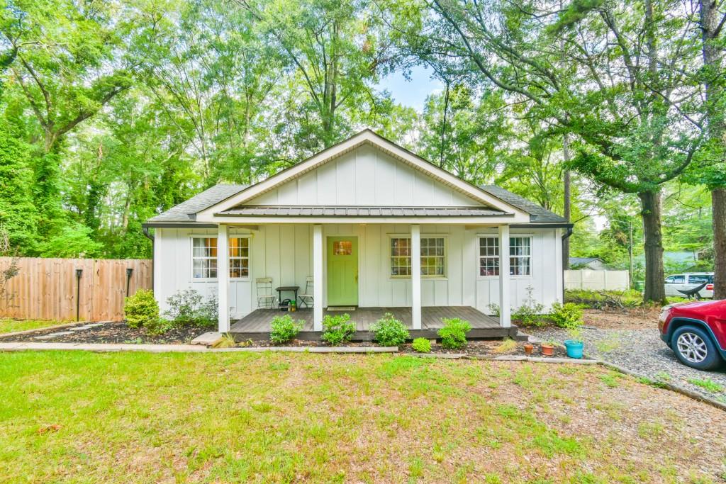 Welcome Home to this adorable renovated cottage just minutes from downtown Monroe! Step into storybook charm with beautifully renovated 3-bedroom, 2-bath cottage nestled on a corner lot in a quiet neighborhood within walking distance of dining & shopping in downtown. Every inch of this home has been thoughtfully updated - from the stylish new kitchen featuring modern soft-close cabinetry, granite countertops & stainless steel appliances, to the fully renovated bathrooms with contemporary fixtures & finishes. New flooring, paint & lighting throughout give the home a bright, welcoming ambiance. The open concept of the living, dining & kitchen area allows for a great flow for entertaining friends around the cozy fireplace. There is a spacious built-in sideboard great for storage and serving. All appliances remain, including refrigerator, washer & dryer. The home features a tankless water heater, newer HVAC, plumbing & electrical. The backyard is privately fenced and has a huge patio with a large serving/prep table that will be great for your cookouts! Enjoy peaceful mornings or quiet evenings on your cozy front porch or great weekend cookouts in the backyard. Whether you are looking for your first home, a quiet retreat, or a low-maintenance lifestyle close to Monroe's shops, dining & events, this move-in ready gem is a must-see!