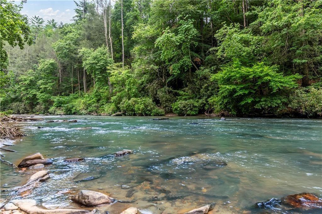 Nestled in a small mountain community on the infamous Mountaintown Creek is this lovely 13.23 +/- acre piece of property awaiting your personal touch to make it a dream vacation home, full-time residence, or successful rental. This property checks every box a prospective buyer could have when considering property in North GA. Want over 1,000 feet of creek frontage on one of the most popular trout streams in North GA? Check! Want a great lot that could offer stunning mountain views with pruning and landscaping? Check! Looking for the right land that can be further divided into several lots to bring along your family and friends and have more than one house? Check! The property has already been soil tested and approved for septic. Tens of thousands of dollars in clearing already done with pre-cut driveways in place. Property lines are clearly marked, and a new survey was recorded just a year ago! Need to make a trip to town? Take a short, approximately 8 mile drive to downtown Ellijay and enjoy restaurants, boutiques, festivals, and more! STRs are allowed. Inquire for more details!