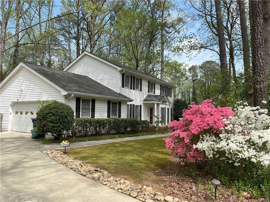 MOTIVATED SELLER!!! A must-see southern traditional located just off Marietta’s tree-lined Old Sewell Road, this lovingly maintained home radiates warmth and timeless charm. Offering an inviting blend of classic architecture and thoughtful updates that honor its heritage. You are greeted by lush gardens that frame the front of this lovely home, while four stately porch columns welcome you like old friends. Step inside and take your time—almost every room has been preserved in impeccable condition, from the rich, solid wood floors to the freshly painted walls. The care poured into this home is evident in every detail. Enjoy spacious rooms, fresh updates, and abundant storage throughout. Please note that although the title says 3 bathrooms, there are 4 bathrooms in the home: 2 full bathrooms upstairs, a half bathroom on the main and a 3/4s bathroom in the finished basement.
The family room invites cozy evenings with its warm fireplace, custom cabinetry, built-in bookshelves, and a welcoming wet bar. Just beyond, a sun-drenched plant room—lit by skylights and overlooking a serene bamboo grove—offers the perfect nook for quiet afternoon reading. The kitchen is thoughtfully designed with a seated island, abundant storage, and an eat-in bay window that frames a gorgeous view of the expansive backyard.
Head upstairs to discover four spacious bedrooms, each with its own distinct personality. The master with ensuite and additional full bath are on this level.
Downstairs, the spacious finished basement includes a convenient three-quarter bath—ideal for washing up after gardening. Step out through the large screened-in porch, where a freshwater spa awaits. Stone pavers guide you to an oversized shed surrounded by lush greenery. While you explore, take a moment to see how many plant varieties you can spot—every corner of this property whispers of the love and attention it’s received.
From the moment you step inside, you will feel the warmth and affection that make this house a true home.