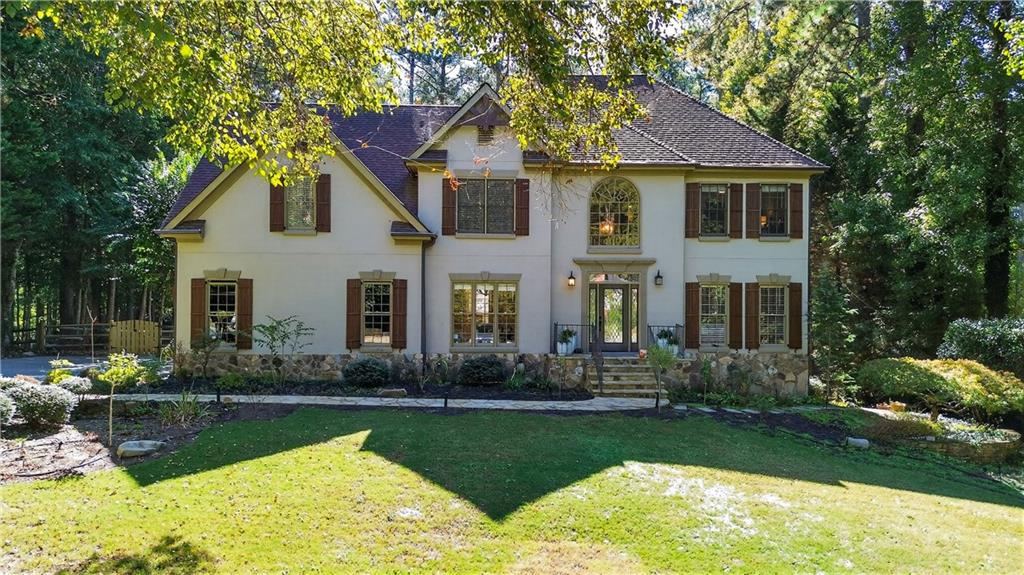 This elegant home perfectly blends sophistication and comfort. The main level features white oak hardwoods throughout the family room, sunroom, office, dining room, kitchen, and Butler’s pantry. The updated kitchen shines with new cabinets, granite countertops, and premium appliances. Upstairs offers four spacious bedrooms with hardwoods, including a primary suite with walk-in closet and spa-like bath, plus a second bedroom with private bath and double closets. Enjoy crown molding throughout and cozy nights by the two-story stone fireplace with cedar beams. The finished basement includes a full bath, bedroom, and flexible living space. Step outside to your private retreat with an inground saltwater pool with slide!, gas stone fire pit, and lush yard perfect for entertaining or relaxing in style.