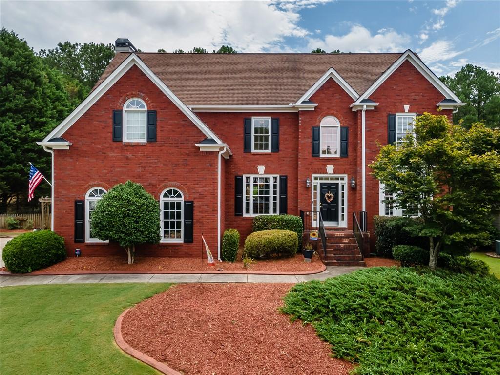 Location and lifestyle combine to make this your next dream home! Just off Towne Lake Parkway and 575, this meticulously-maintained 4 bedroom home with a luxurious POOL and finished terrace level is ready for you! Beautiful, pristine landscaping greets you as you pull up to this stately home. The grand entry foyer opens up into the lofty great room with the first of THREE FIREPLACES, and big enough for a grand piano! The kitchen is large and finished with high-end cabinets and counters. You'll love the sitting area/eat-in kitchen with another fireplace. From there step out into the backyard oasis, where you'll find the lovely POOL, deck, and private fenced yard. The large separate dining room allows for plenty of seating; sure to please the entertainer. Before you head upstairs, notice the bedroom on the main level, just off the great room; perfect for guests or as an office. Upstairs are three more bedrooms, including the OVERSIZED PRIMARY ensuite with the third fireplace. So much space...and the closet is a room unto itself. The two secondary bedrooms are nicely sized with plenty of closet space. Heading to the FINISHED BASEMENT, you'll find a large LIVING area, full bath, and plenty of storage. There is also a BOAT GARAGE on this level - accessible from inside and outside the home. Don't delay...schedule your private showing today!