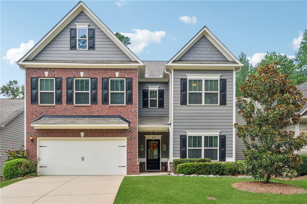 Welcome to this beautifully maintained 4-bedroom, 3.5-bathroom home in the highly desirable Cornerstone Manor community. Built in 2014, this 3,600 sq ft residence offers a perfect blend of space, style, and functionality in a prime location. The open-concept main floor is ideal for both everyday living and entertaining, featuring a massive family room, dining area, and kitchen that all flow seamlessly together. You'll love the rich hardwood floors throughout the main level, adding warmth and sophistication to the living spaces. The kitchen is a standout with its espresso cabinetry, granite countertops, an oversized island, and plenty of counter and storage space. Just off the main living area is a dedicated office with French doors, perfect for remote work or study. Step out onto the large screened-in porch—a peaceful retreat for relaxing or entertaining—overlooking a flat, usable backyard. Upstairs, you’ll find four spacious bedrooms and three full bathrooms, including a private en-suite in one of the secondary bedrooms. The owner’s suite is a true highlight with a tray ceiling, generous proportions, and a luxurious en-suite bath featuring a tiled shower, dual vanities, and ample closet space. A large loft area offers flexible space for a game room, media center, or teen hangout. Located just minutes from downtown Woodstock and Roswell, this home offers easy access to vibrant shopping, dining, and entertainment options. Zoned for top-rated schools: Little River Elementary, Mill Creek Middle, and River Ridge High.