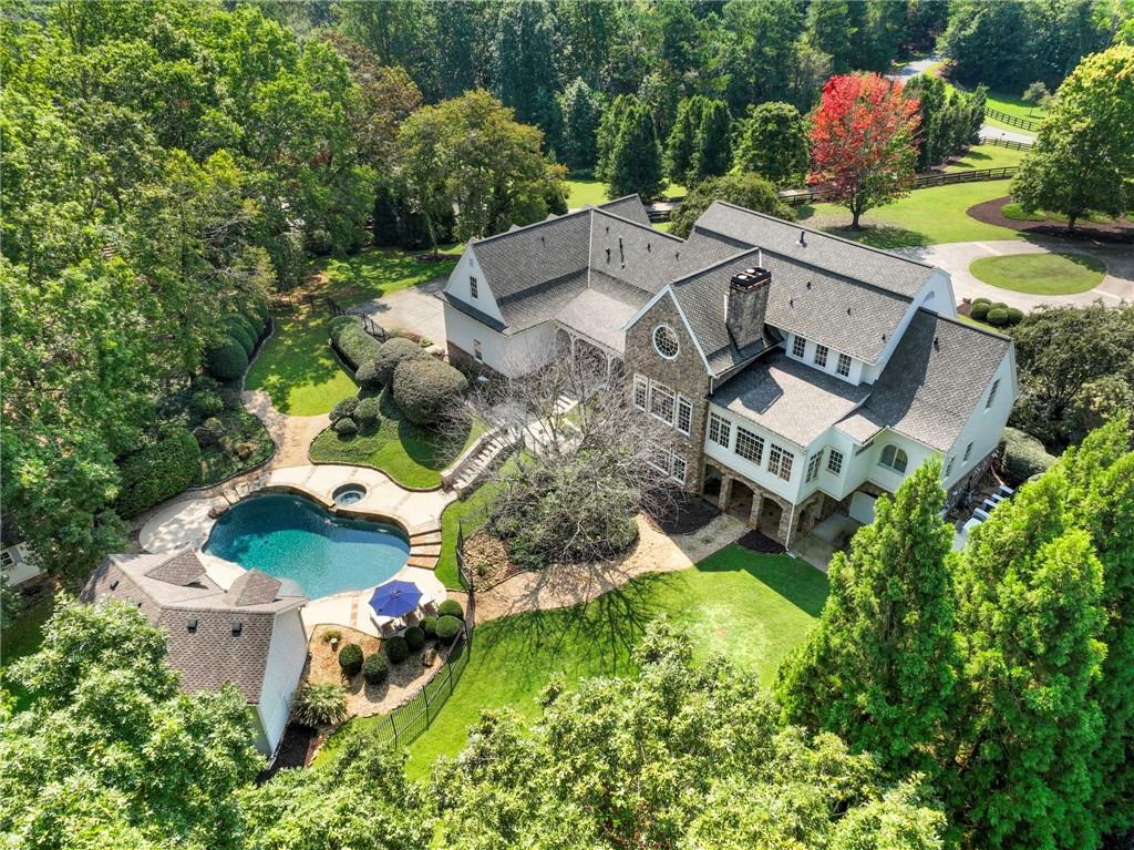 FIRST TIME ON THE MARKET! A RARE OPPORTUNITY TO OWN A SOUTHERN ESTATE ON 5+ ACRES IN DAWSONVILLE'S EXCLUSIVE GATED COMMUNITY! Welcome to your own private retreat-where timeless Southern elegance meets modern luxury. This hidden gem, tucked away on more than five acres, offers the rare combination of complete privacy, breathtaking natural beauty, and the warmth of refined design. From the moment you arrive, the setting captures your heart. A long, tree-lined driveway winds its way to a circular drive surrounded by lush landscaping, while a grand rocking-chair front porch greets you with the charm and grace of true Southern hospitality. Every detail of this estate has been thoughtfully reimagined with over $300,000 in custom upgrades since 2019, creating a home that is both sophisticated and family-friendly. Inside, sunlight spills across gleaming hardwoods, illuminating a graceful dining room, private office, and an inviting great room anchored by soaring windows with serene views of the backyard oasis. At the heart of the home is a designer kitchen that any chef or busy mom will adore. Outfitted with Sub-Zero and Wolf appliances, a prep kitchen, and a custom open layout, it's designed for effortless family meals, entertaining, and everything in between. The main level primary suite feels like a true sanctuary, with a spa-inspired bath, an oversized walk in closet with its own washer/dryer, and tranquil views that make mornings feel like a retreat. Upstairs, four spacious bedrooms each with its own private bath provide every family member or guest their own personal haven. The finished terrace level transforms into an entertainer's dream: a full second kitchen, fitness/playroom, bedroom and bath, plus a cozy fireplace perfect for gatherings. Step outside, and the lifestyle you've dreamed of unfolds a sparkling heated saltwater pool and hot tub, pool house, and covered outdoor lounge where laughter and memories come alive, all framed by mountain breezes and the sounds of nature. Peaceful, private, and perfectly polished. This is more that a home-it's an irreplaceable lifestyle, nestled in one of Dawsonville's most exclusive gated communities yet just minutes from every modern convenience. Located near North Georgia Premium Outlets, Lake Lanier, restaurants, fantastic parks and the majestic Blue Ridge Mountains, this home offers a lifestyle that dreams are made of. With wineries not to far away, you'll have endless opportunities to indulge in the finest that Georgia has to offer. Welcome Home!