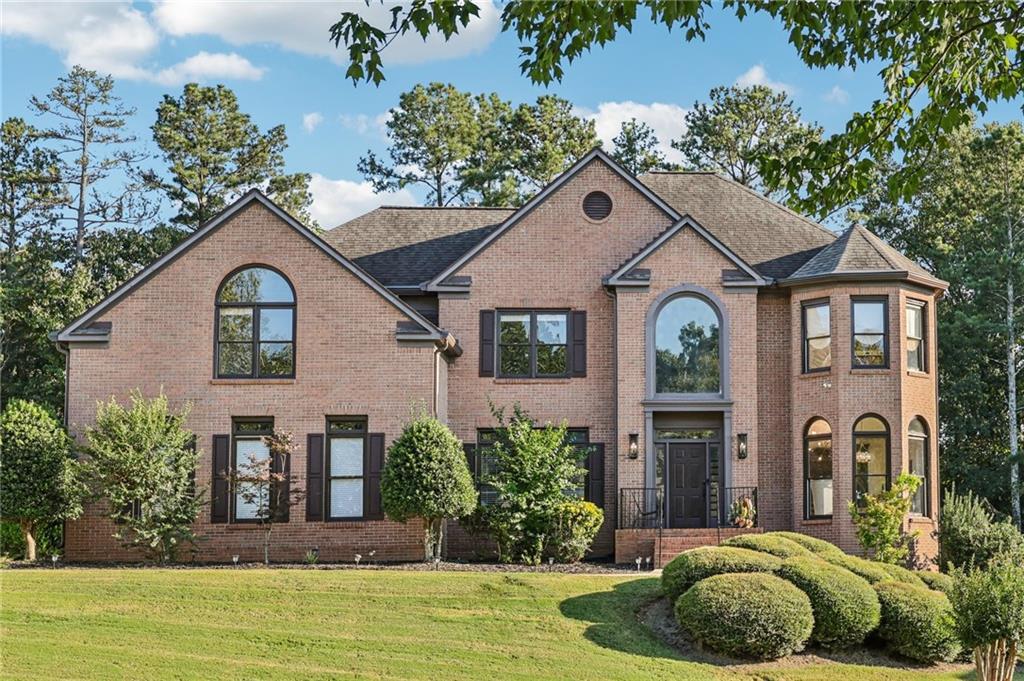 EXQUISITE three-sided BRICK HOME situated in prestigious OldeBranch section of the sought after MORNINGVIEW neighborhood, with TOP-RATED SCHOOLS and UNMATCHED AMENITIES! This ORIGINAL OWNER has maintained and upgraded over 3,900 square feet of above ground living space, and an additional 2,000+ sq ft of FULLY FINISHED BASEMENT (2016) complemented by a HUGE 3-car garage (850 sq ft!). The home has undergone extensive updates, including a COMPLETE KITCHEN RENOVATION in 2021 and ALL above ground BATHROOMS COMPLETELY UPDATED in 2025! TOO MANY UPGRADES TO LIST!! The TRUE CHEF’S KITCHEN, features a 10’ center island with back-lit BLUE LOUSIE EXOTIC QUARTZITE 10’ island and main sink, additional prep sink, ALL UPDATED APPLIANCES, including Fulgor Milano SIX BURNER PROFESSIONAL GAS RANGE with hibachi griddle and pot filler, separate Fulgor Milano STEAM OVEN, Wolf brand SPEED OVEN, Miele Programable BUILT-IN ESPRESSO MACHINE with grinder, Elkay refrigerated BUILT-IN FILTERED WATER STATION, Fulgor Milano paneled BUILT-IN REFRIGERATOR paneled Miele SILENT DISHWASHER, and Zeffler under counter BEVERAGE COOLER. ALL NEW custom inset solid maple cabinetry with soft-close cabinets and oversized drawers, built-in storage features, and under-cabinet lighting! Upstairs, the oversized owner’s suite was completely renovated in 2025, and boasts of a jacuzzi soaking tub, tile walk-in shower, dual vanities, and a huge walk-in closet with his-hers sides. there are also three additional spacious bedrooms and two additional FULLLY RENOVATED SECONDARY BATHROOMS upstairs. The sellers COMPLETELY FINISHED the BASEMENT less than 10 years ago, adding an additional HVAC unit and an additional Electrical Panel with 220 voltage. The basement features a well-equipped media room with a fully installed electric fireplace heater, 2 generous sized bedrooms, a full bathroom, and a fully integrated wet bar with under cabinet lighting, wine rack and beverage cooler AND FULL KITCHEN, both featuring all new custom inset solid maple cabinetry with soft-close cabinets, Fisher Paykel refrigerator/freezer, double Kenmore Elite ovens, and 5 burner gas cooktop, making this space ideal for entertaining or multi-generational living! Structural and mechanical updates to the home include a ROOF LESS THAN FIVE YEARS OLD, two HVAC systems replaced in 2018 (third one is 2016), all new gutters (2022), All-updated light fixtures (2022), new neutral interior paint throughout, and new interior doors on the main level. Nestled on a private lot with mature landscaping, this MORNINGVIEW home offers direct access (across from the clubhouse) to over 10 miles of walking and biking trails, is a short walk to George Pierce Park, and just 2.5 miles to Suwanee Town Center, library, farmers market, coffee shops, and dining. Community amenities include a clubhouse, THREE POOLS including a splash pad and WATER SLIDE, newly resurfaced tennis and pickleball courts, playground, BRAND NEW clubhouse fitness center (coming in 2025!) and an active HOA. This home has been meticulously maintained and thoughtfully improved—perfect for buyers seeking luxury, lifestyle, and LOCATION!