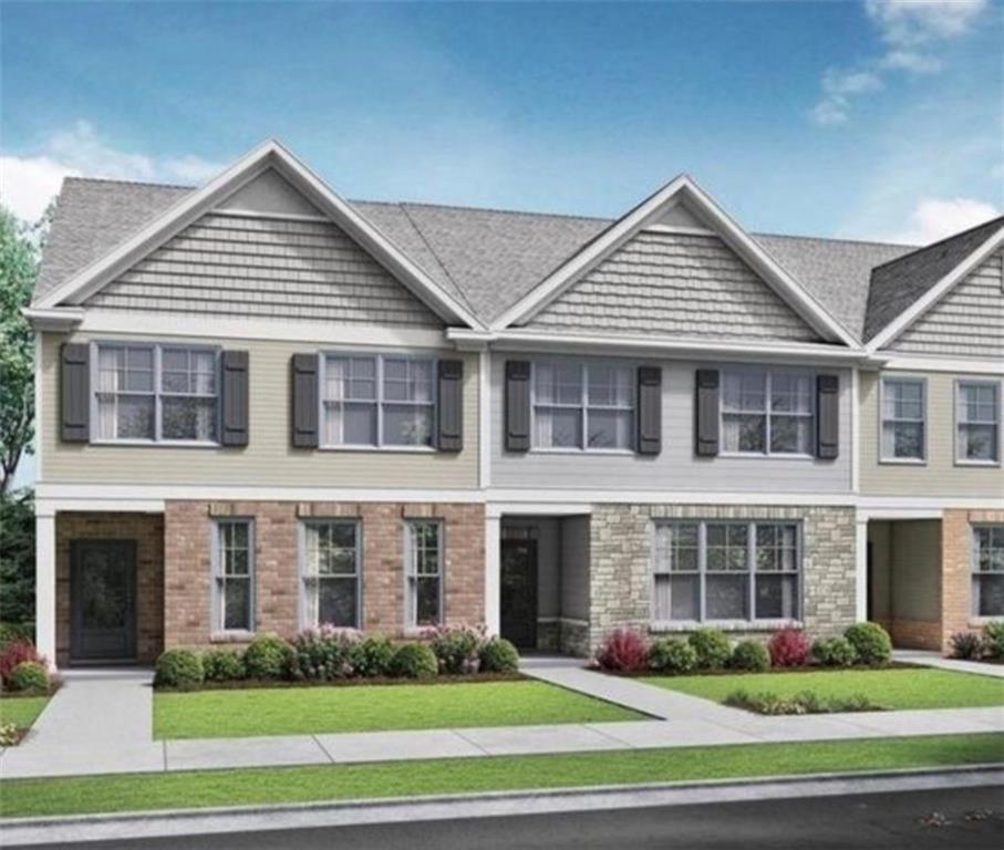 Modern townhome exterior featuring an architectural shingle roof, decorative gables with shake siding, and a combination of brick and stone facade elements