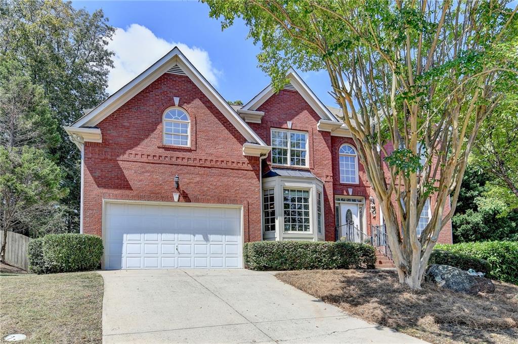 Experience unparalleled living in this stunning brick-front residence, designed for both comfort and style. A grand double foyer and elegant hardwood floors welcome you to an open, flowing floor plan. The versatile main level features a private in-law suite and a dedicated home office, offering flexibility for a modern lifestyle. Upstairs, the expansive primary suite is a serene retreat, complete with a generous bonus room that can serve as a second office, oversized closet, or sitting area. The upper level also provides a beautiful, airy flex space, perfect for a media room, playroom, or art studio.
The heart of the home is an open-concept living area where a cozy, stone-clad fireplace anchors the family room, which flows seamlessly into a separate breakfast room and a charming breakfast bar. Step outside to a screened-in patio, where you can enjoy peaceful moments overlooking the serene, fenced-in backyard. A full unfinished basement! This home is conveniently located with easy access to major interstates, premier shopping, and dining.