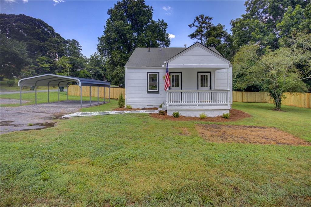 White exterior with a covered porch featuring white railings