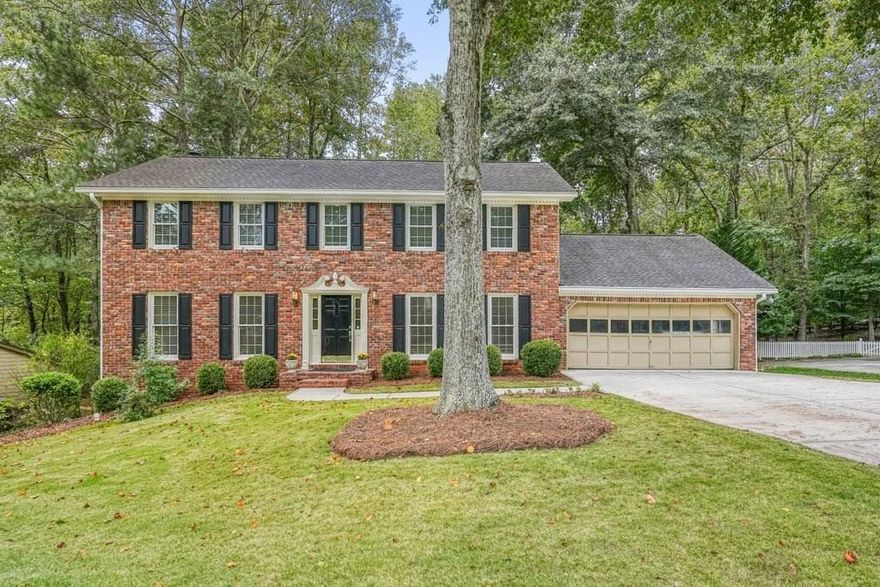 This is the home you've been waiting for! Brick beauty in the heart of East Cobb/Pope HS district with walkability to Tritt ES school and all of the amazing amenities that Chimney Springs offers - playground, pool, tennis courts, clubhouse and lake! Special features include flat half acre lot, two fully equipped kitchens and two equipped laundry areas!  Newer, extended driveway with parking pad and sidewalks make a good first impression to welcome guests. Backyard gate opens to a park-like lawn with stone paths leading to a vine shaded swing, built-in firepit and solid storage shed, with multiple zone irrigation system, Rainbird timer and path lighting. A nice deck and screen porch overlook the scenic yard. An updated sunny white kitchen has stone counters, gas range, framed vent hood, large island and pantry. It will be a pleasure to spend time in a spacious laundry room adjacent to the kitchen, with a second walk-in pantry and a roomy built-in table with a stone top, ideal for folding clothes, wrapping gifts or other projects. Hardwood floors run through the main level living & dining spaces. Primary suite and 3 secondary bedrooms are located on second floor. Primary bath features a newer vanity with stone top and frameless glass shower. The secondary bath is a generous size with double sinks, stone counter top and 2 decorative mirrors. Basement is completely finished and could be a guest suite / apartment boasting a full kitchen, living area, bedroom, flex room, full bath and the second laundry area.  Exterior entrance is a step-out to the patio with a newer double door with built-in blinds. Great location, sought after school district, amenity-rich community, park-like backyard, 2 fully equipped kitchens, 2 laundry rooms with washers & dryers, spacious & bright living spaces - this home has it all!