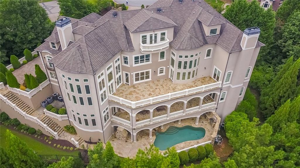 This exquisite European 18,000 sq. ft. home sits on the highest elevation in Country Club of the South. It offers magnificent unobstructed vistas for miles. The home was custom designed with five expansive and unique floors all served by a 5-story full-size elevator making complete access just a push button away. From the sky loft to the ultra-private saltwater pool and spa and outdoor kitchen make this home an entertainers dream. This home offers so much in luxury living its hard to envision. The $200,000 bronze-sculpted fountain is the focal point for the entry courtyard leading to a majestic column 25' high covered entry. From the moment you enter its high quality fit and finish is clearly evident at each unique level, enhanced by stately and impressive walls of glass flooding natural light throughout. The two-story library is a work of art, located just off the foyer. The home features three kitchen, three laundry rooms, three steam saunas, a home theater that is 2nd to none, wine cellar, and a spectacular indoor 3/4 professional basketball court, exercise gym, multiple bars, card room, 7 fireplaces, outdoor balconies for huge parties, and the list is seemingly endless! Come join us to tour this home truly built for the lifestyle you desire.