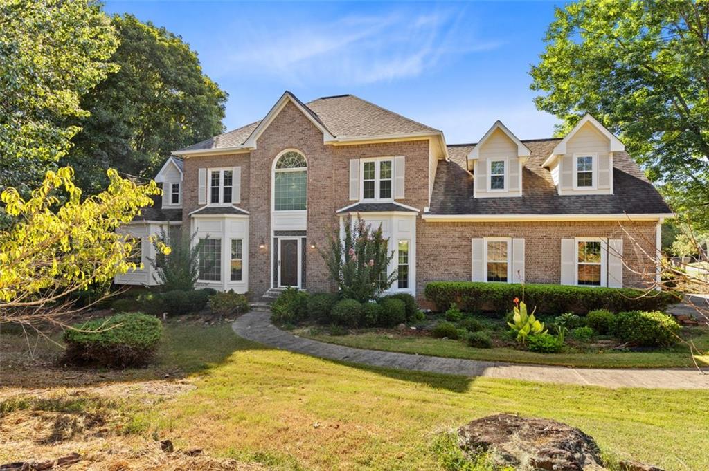 Welcome to this stunning three-sided brick home in East Cobb!
Thoughtfully updated with new siding, energy-efficient windows, and professionally installed leaf gutters, this residence blends classic charm with modern comfort. The spacious main-level primary suite boasts a tray ceiling and a luxurious bath, while the open-concept kitchen flows seamlessly into the family room and sunroom—perfect for everyday living and entertaining. Hardwood floors highlight the main living areas, complemented by newly installed carpet in select spaces. Upstairs, generous bedrooms provide comfort and versatility for the whole family. The daylight basement, partially finished with a workshop, adds even more flexibility for work, play, or hobbies—all set on a beautifully landscaped lot.
Situated in the highly sought-after Lassiter High School district, ranked among the best in Georgia, this home is nestled within a safe, family-friendly community just 20 miles from downtown Atlanta. Residents enjoy easy access to The Avenue East Cobb for shopping and dining, local parks for recreation, and major grocery stores just minutes away.