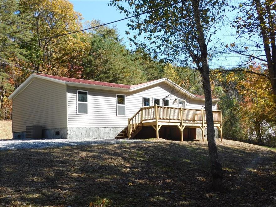 Beautifully Remodeled Home – Move-In Ready and Full of Charm!  Welcome home to this completely transformed property that’s truly better than new! Every inch of this home has been thoughtfully updated to create a fresh, comfortable, and low-maintenance living space. From the brand-new metal roof and siding to the energy-efficient windows, interior and exterior doors, and stylish light and plumbing fixtures, no detail was overlooked.  Step inside and you’ll immediately notice the warmth of the new LVP flooring that flows throughout the home. The kitchen shines with brand-new cabinetry, beautiful countertops, and all-new stainless-steel appliances — perfect for everyday meals or weekend gatherings. Both bathrooms have been completely remodeled with modern finishes and clean, timeless design.  Outside, enjoy the brand-new front and rear decks, ideal for grilling with friends, or taking in the peaceful surroundings. The home sits on a permanent foundation with retired titles.  Located on a county-maintained paved road, this property offers easy access to Historic Downtown Dahlonega, UNG’s campus, and several local wineries, hiking trails, and mountain attractions — all while enjoying the privacy and freedom of no HOA.  If you’re looking for a move-in-ready home that blends quality updates with a relaxed North Georgia lifestyle, this one is a must-see.