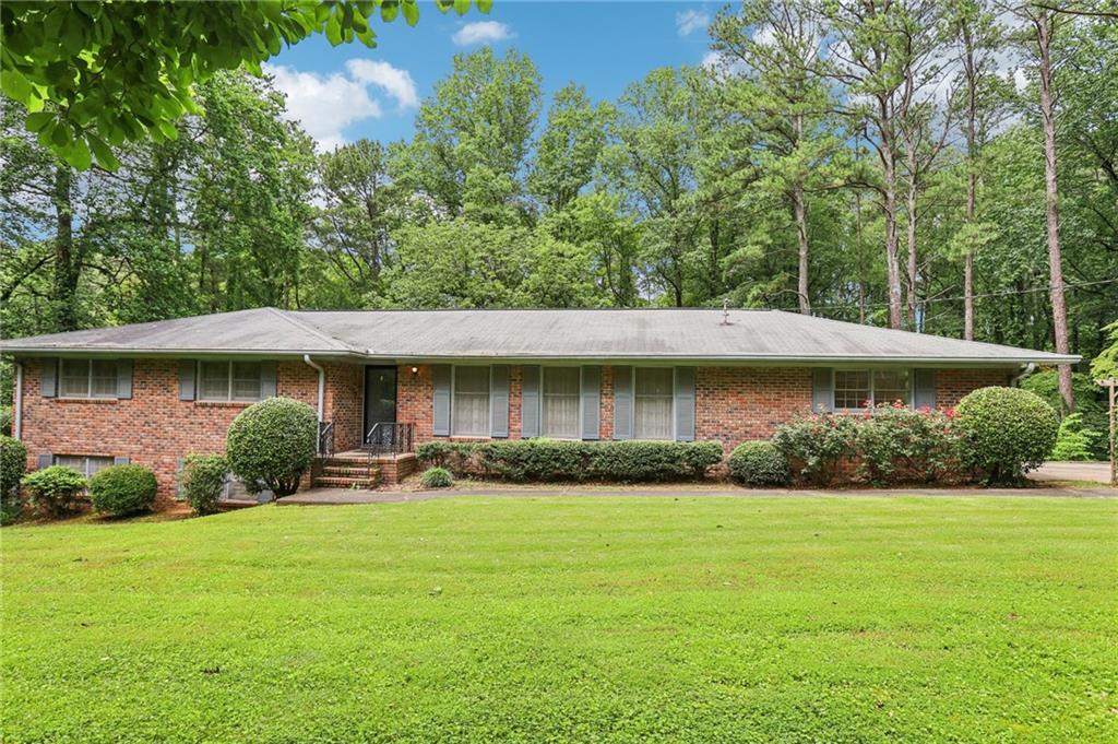 Welcome to 415 Haven Ln — a private and spacious sanctuary nestled on a serene 1.9-acre wooded lot in sought-after Marietta. This beautifully maintained 5-bedroom, 3-bathroom home offers the perfect blend of comfort, functionality, and natural beauty.
Step into a light-filled living and dining room that immediately invites you in with warmth and openness. The thoughtfully designed kitchen overlooks a cozy fireside family room, creating the perfect setting for everyday living and entertaining. A sunroom at the back of the home showcases views of the private, wooded lot and offers a peaceful spot to relax and enjoy nature year-round.
The primary suite is conveniently located on the main level, providing privacy and ease of access. The fully finished terrace level includes an in-law suite complete with two bedrooms, a full bathroom, its own kitchen, and a spacious living area — ideal for multigenerational living, guests, or rental potential.
Step outside to a generous backyard that feels like your own private park. Multiple decks offer ample space for entertaining, dining, or simply soaking in the tranquil surroundings. A garden area and views of the nearby lake complete this idyllic outdoor setting.
Don’t miss this rare opportunity to own a versatile home with so much to offer — all just minutes from top schools, shopping, and dining in East Cobb.