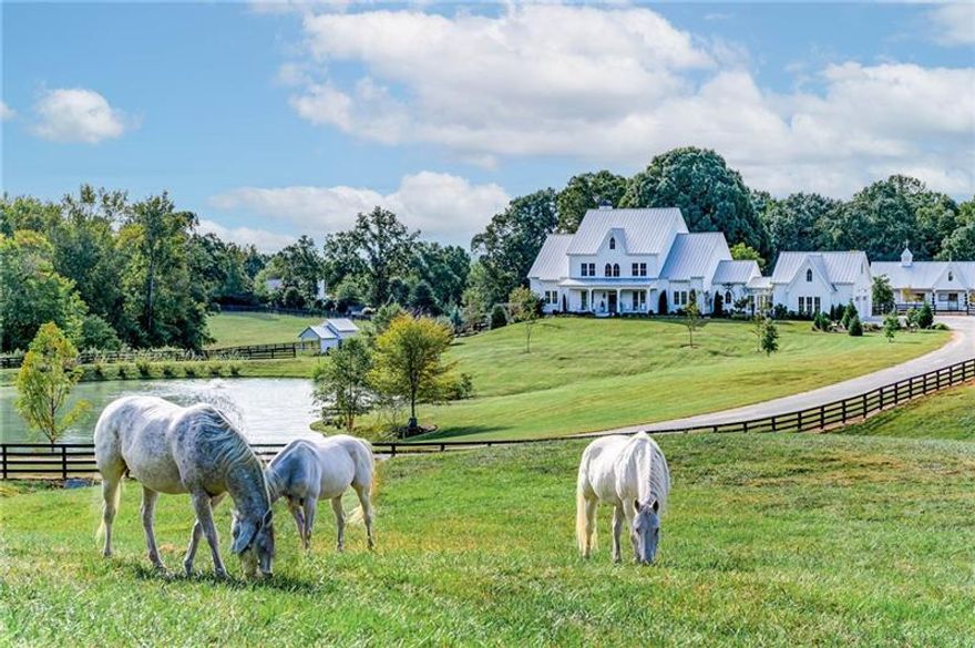 If you're searching for a once-in-a-lifetime property, look no further than Dara Hill Farm. This stunning 2019-built farmhouse estate is situated on 40 picturesque acres in highly desirable Southeast Canton. Upon entering the property, you are greeted by the beautiful equestrian landscape, rolling green pastures, and breathtaking views of the incredible 4-bedroom (plus office/5th bedroom) and 4.5-bathroom custom estate home that overlooks a tranquil stocked pond.   Designed by a true equestrian, your horses and animals will be happy to call this place home in the 5-stall insulated custom barn featuring 12'x14' stalls w/ attached private runs, automatic waterers, fly spray system, and interlocking mats. The barn has a thoughtfully designed, fully fenced courtyard/barnyard w/ a climate-controlled tack room, feed room, hay room, wash stall w/ hot/cold water, and a stunning 1175 sqft Studio. There are seven fenced pastures, all w/ automatic waterers.   The main house, pool, barn, and garden were all designed around a 100-year-old oak tree, which is the heart of the remarkable English-style garden. Boasting luxury finishes and impeccable attention to detail, the owners, spent two years collecting reclaimed items and antiques to build this house around. A home out of the pages of Architectural Digest, you enter through the reclaimed antique English door featuring a custom stained-glass transom. The 2-story grand foyer has balusters reclaimed from a 19th-century Philadelphia home and is decorated with an oversized Visual Comfort Movarian Star chandelier. The interior offers spacious open-concept living with beautiful rough-sawn white oak floors. The home is centered around the generously sized living and sitting room that features a fireplace w/ reclaimed mantle and beams. A continuation of the indoor living space is the rear porch which offers a beautiful, whitewashed brick fireplace w/ a gas starter, TV outlet, custom mantle, and copper lanterns. The elegant kitchen has beautiful marble counters, custom cabinetry & hardware, a 6' Lacanche range, custom white oak hood, 4' True refrigerator, Perrin and Rowe English faucet, reclaimed pocket doors from an Ohio church, and a butler's pantry w/ an additional sink and refrigerator. The main level owner's suite has Designer's Guild wallcoverings, his & her closets w/ California Closet system being installed in November, antique 19th-century French doors from Paris, antique rectangular claw foot soaking tub from Paris, vintage chandeliers, and a private screened sleeping porch w/ queen size swing bed. The main level is complete with a dining room, boot room, large laundry room w/ vintage utility sink & folding table, guest bathroom, and oversized 3-car garage. The upper level offers 3 spacious bedrooms, a large office (or possible bedroom), and 3 full bathrooms w/ designer wallcoverings, each w/ unique finishes & bathroom fixtures.   Enjoy a stroll through the beautiful, irrigated gardens leading to the private pool, which includes fruit trees, shade trees, a cutting and vegetable garden, seasonal flowers, and over 300 peonies. The heated salt pool offers ample decking w/ a pergola for entertaining, Stonescape pool finish, and a raised waterfall spa. There is an original 1960s farmhouse that was fully renovated into a 1-bed and 1-bath caretaker's cottage. The property has trails throughout and on the perimeter, as well as a 1.5 Acre fenced arena/jump field. The stunning topography has lightly wooded areas, meadows, pastures, and the babbling creek that runs through the property. This is the perfect place for a daily morning walk or ride and is home to wildlife, including deer families and a stocked pond.  Finally, this home is in the sought-after Creekview Highschool district. It is less than 10 minutes from 7 Acre BarnGrill, Scottsdale Farms, and Milton Publix; less than 15 minutes to Milton's Crabapple District; and just 20 minutes from downtown Alpharetta, Avalon, and GA-400.