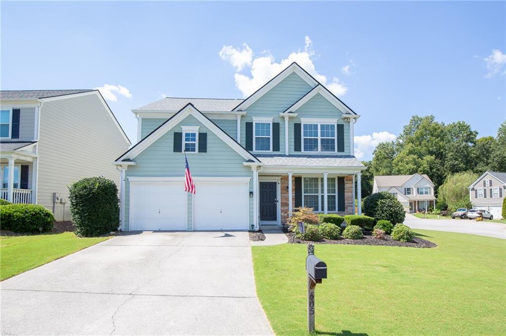 Welcome to the sought after community of Woodlands neighborhood! Close to everything Woodstock has to offer, including just minutes from the growing downtown area. This 3 bedroom, 2.5 bath home has been updated from top to bottom! Features include smooth ceilings, updated light fixtures, NO carpet, updated kitchen and bathrooms, newer roof, newer hot water tank, two story living room, open concept main areas, cozy fireplace, and great primary bedroom walk-in closet with built-ins. The updated kitchen and bathrooms offer white cabinets with quartz counters and stainless fixtures. The primary bathroom has been meticulously updated with a beautiful soaking tub and marble throughout. The eat-in kitchen features a new sliding door that opens to a private, fenced, backyard, perfect for outdoor meals and fun! The second floor laundry room has been updated with tile and cabinets. Other features/updates include: split HVAC system (two thermostats), Honeywell smart thermostats, updated exterior fixtures, smart doorbell, updated HVAC system, updated LG kitchen appliances, new chimney cap, and spacious corner lot. The neighborhood amenities include a large pool (with kids pool and waterslide), secondary pool, large clubhouse, basketball courts, tennis courts, beach volleyball court, an extensive playground, walking trails, pickleball courts, and access to the newest Woodstock public park (back of the neighborhood). Convenient to I-575 (approximately 5 miles) with access to the express lanes. This home is completely move in ready and a must see! Welcome home!
