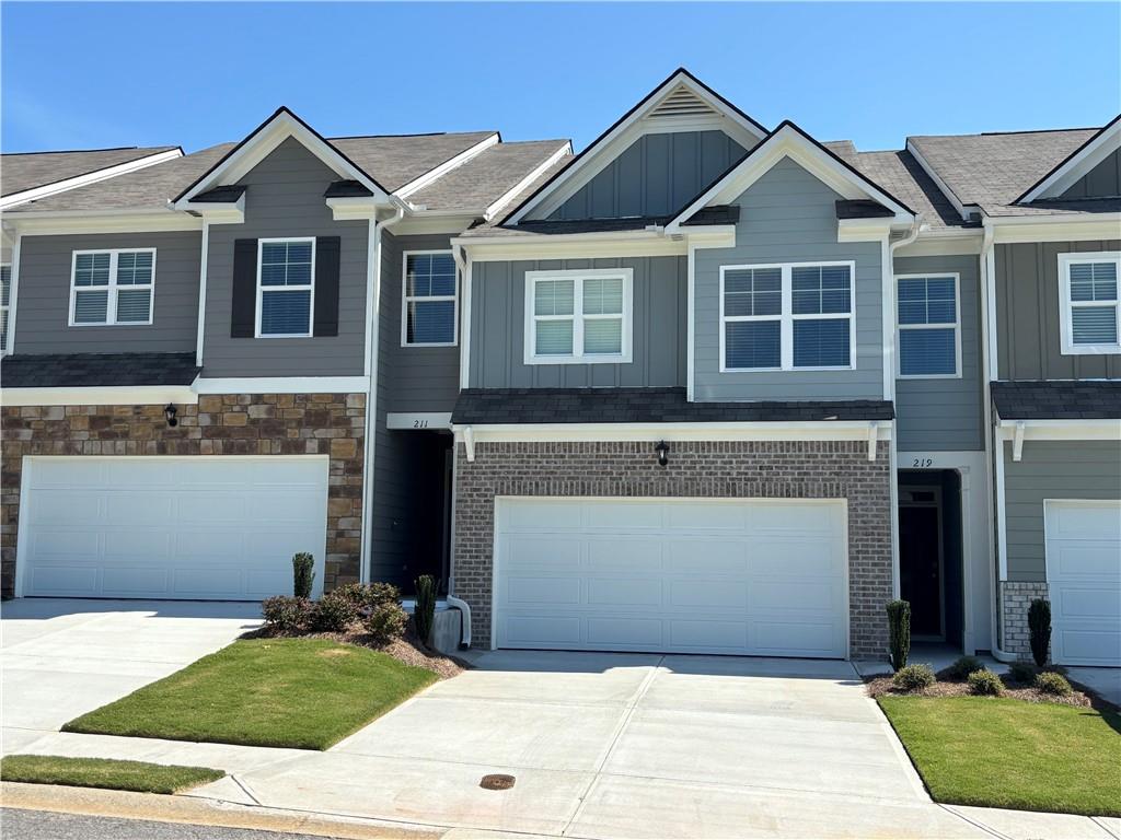 Mountain Park home featuring 3 bedrooms and 2.5 bathrooms in 1,877 square feet along with a 2-car garage. As you step off the front porch, a long foyer welcomes you and leads into the open-concept main living area. A large family room boasts a sleek electric fireplace mounted on the wall. The family room flows seamlessly into the well-appointed kitchen with a center island, granite countertops, subway tile backsplash, white shaker-style cabinetry, and stainless-steel appliances. A dining area directly off the kitchen provides space for a dining table and opens onto the back patio. There is also a half bathroom tucked away on the first floor. Up the stairs you'll turn from the landing into the primary suite. A spacious bedroom is complimented by the en suite bathroom featuring a separate tub and shower, dual vanity, water closet, linen closet, and a roomy walk-in closet. Across the landing you'll be led into a loft area that's perfect for a second living space for family and friends to gather or for a quiet night with a book or movie. 2 secondary bedrooms, the laundry room, and an additional bathroom, also with dual vanity, round out the upper floor.