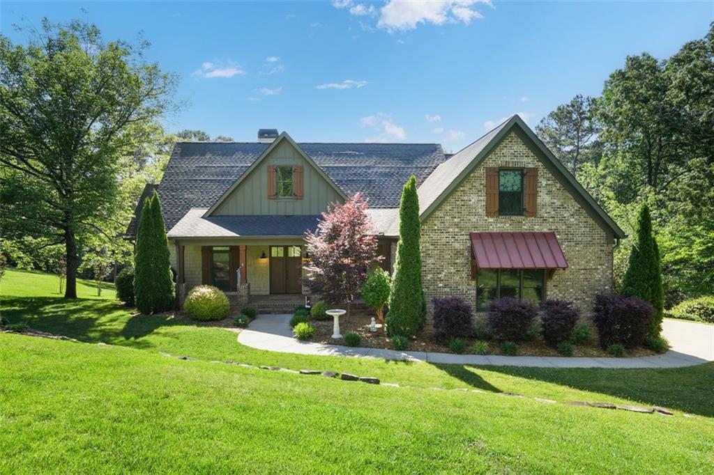 This custom-designed home, located mere feet from the pristine waters of Lake Lanier, embodies both elegance and innovation.
Located in the coveted South Lake area of Lake Lanier, this tranquil property is just under an acre, at the end of a quiet street, and features a deep-water covered single slip dock. Enjoy perfect lakeside living with easy access to Margaritaville at Lanier by boat and a short drive to GA400.
The architecture welcomes you with a bright and open great room, featuring large French doors and windows that offer captivating lake views and connect seamlessly to private outdoor living spaces. The luxurious kitchen is a chef's delight, equipped with stone countertops, a massive island, WOLF range, hood, oven, microwave, and a custom SubZero glass refrigerator. The primary suite on the main level offers lake views and direct access to the rear deck. The primary bathroom features a soaking tub, frameless glass shower, double vanities, and a spacious walk-in closet. Two additional bedrooms on the main level share a jack-n-jill bath. The home’s terrace level includes new in-law/guest accommodations with a private entrance, custom kitchen with quartz countertops, two recreation spaces, two bedrooms, a full bath, laundry hook-up, and breathtaking lake views through a wall of French doors. Additional storage is available in the unfinished basement area. The property boasts 267 feet of lakefront with a gentle slope and exceptional privacy. Year-round outdoor enjoyment is guaranteed with a screened-in porch that captures the cool lake breezes. Above the garage, an oversized finished space serves as an ideal guest room or teen suite, complete with a private bath and climate control. Discover the quality family time and entertaining opportunities that await in this unparalleled lakefront home.