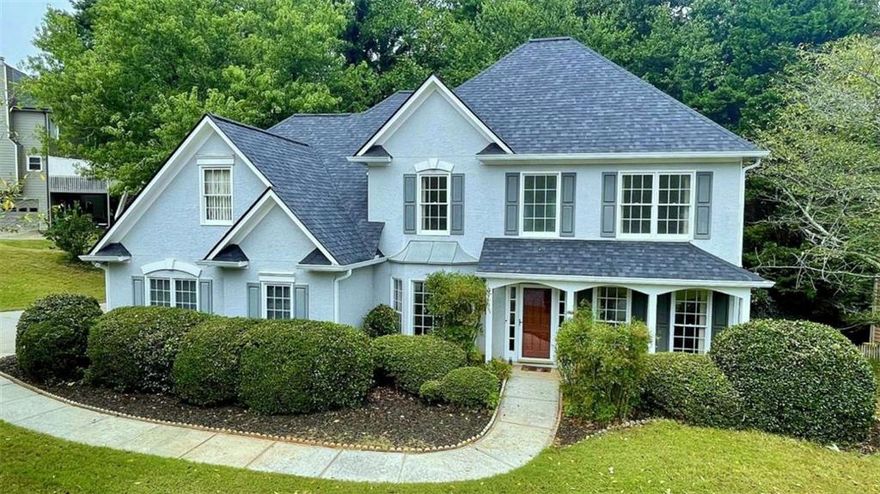 Rare opportunity to own this stately two-story home in the heart of Towne Lake, just minutes from Downtown Woodstock's dining, entertainment, shopping, outlet mall, Lake Allatoona, and Olde Mill Park! Nestled on a corner lot with extra parking space in the highly sought-after, established Deer Run North community, this home offers resort-style amenities including a pool, pickleball, tennis, basketball, clubhouse, and scenic walking trails. Located within top-rated school districts with easy access to I-575 for a smooth commute to Atlanta or the North Georgia mountains. Recent updates include a new roof, fresh interior paint, and an upgraded back deck. The home welcomes you with a grand two-story foyer, separate dining room with bay window, and a office/study with crown molding. Hardwood floors span the main level, leading into a stunning two-story fireside family room with open railing view to the upstairs. The bright, open kitchen features white cabinetry, stainless steel appliances, and tile flooring. The main-level primary suite boasts a vaulted ceiling, walk-in closet, and a private bath with double vanity, garden tub, and glass-enclosed separate shower. A guest half bath, laundry room, large storage closet, and side-entry two-car garage complete the main level. Upstairs features a hardwood hallway, three spacious secondary bedrooms, a guest bathroom with double vanity and tub/shower combo, and a large walk-in attic space above the garage, perfect for storage or potential future expansion. Two additional closets offer even more storage. Enjoy outdoor living on the extended deck and patio overlooking a private, fenced backyard surrounded by mature trees, creating a serene retreat. This vibrant swim/tennis community with sidewalks throughout is the perfect place to call home, don't miss this one-of-a-kind opportunity; schedule your private showing today!  Special Buyer Incentives Available! Take advantage of the Buy Before You Sell Program, enjoy a one-year temporary rate buydown (1% below market rate) OR a closing credit at no cost to the buyer, courtesy of Mark Baker/SWBC Mortgage.