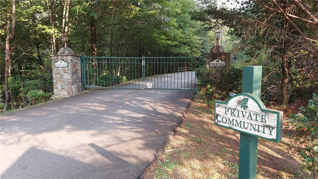 Looking for a building lot in East Ellijay? Don't' miss this opportunity to grab a little over an acre and a half in a gated community. Building restrictions prevent mobile homes, and anything under 1500 sq ft. Located near all the apple orchards and festivals, vineyards, 20 minutes to downtown Blueridge, hiking nearby, beautiful mountain community. You can build now, or hold the land until you are ready. Will need gate code, and all buyers must be accompanied by agent.