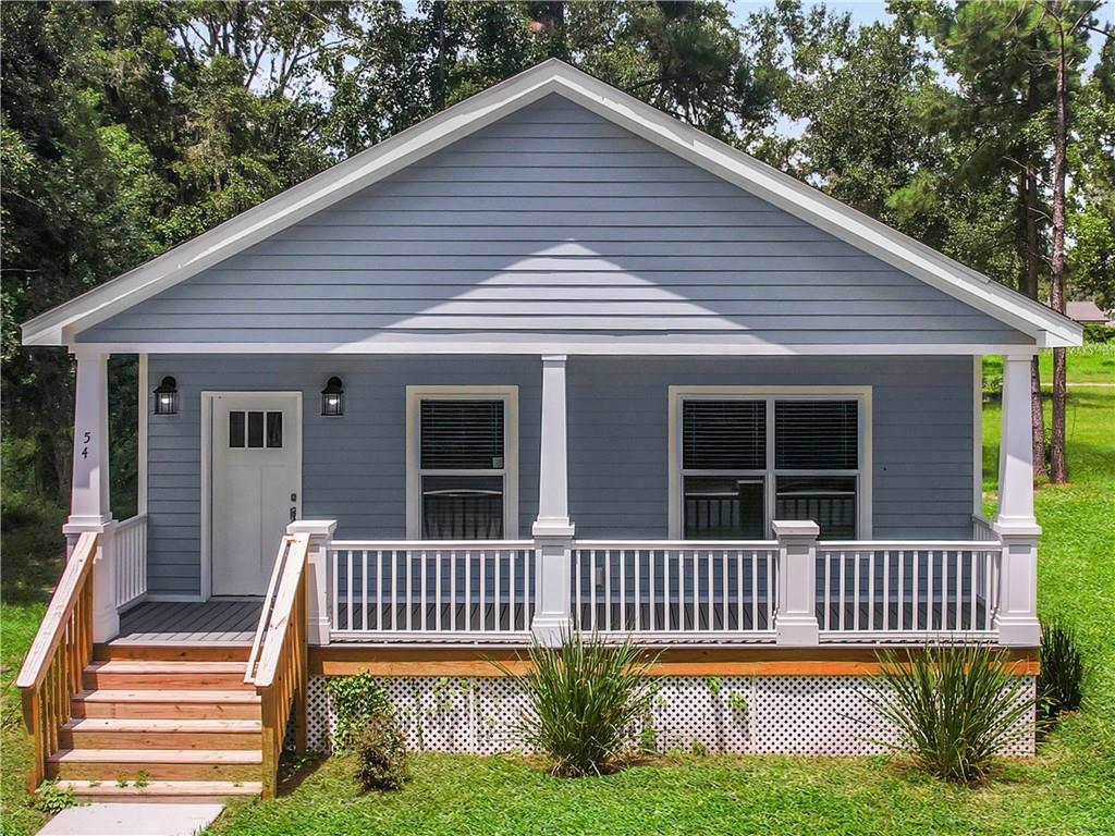 Welcome to 54 Pear Street in the City of Ludowici, GA. Located only 25 minutes from Fort Stewart and Hinesville, this high finish bright open concept floor plan home is the perfect spots to call home. The house has 9' ceilings, crown molding and luxury vinyl plank floors throughout. The open living room and kitchen are perfect for entertaining. The kitchen features granite countertops, all stainless steel appliances (refrigerator included), and an area suitable for a full size dining table. The owner's suite features a walk-in closet, an en-suite bathroom with double vanities and lots of daylight. A large mudroom/laundry room is centrally located with a side entrance to the home between the two additional bedrooms. Built with all Hardie board siding, composite decking, energy efficient systems, windows, insulation and appliances, maintenance on this home will be exceptionally simple! This home comes with a FOUR-YEAR HOME WARRANTY, and the roof is rated to withstand hurricane force winds of up to 140 miles per hour. No HOA! This is Modular Construction built partially in a controlled environment by Impact Housing in Baxley, GA out of high quality materials. This home qualifies for 100% Financing through VA, FHA and Conventional Products. This is also a Georgia Dream and USDA Compliant home!