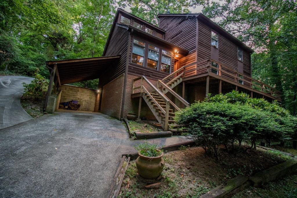 This charming home is nestled in the serene city of Smyrna, surrounded by mature landscaping and a backdrop of lush woods and trees, providing a tranquil retreat from the hustle and bustle of city life. Step inside to discover a unique sunken living room with a cozy fireplace, perfect for relaxing evenings. The main level hosts the primary bedroom, offering convenience and privacy. The kitchen is a chef's delight, featuring Wellborn cabinets with ample storage space, granite countertops, and a stylish tile floor. The outdoor space is equally inviting, with a deck that wraps halfway around the home-ideal for entertaining or enjoying peaceful mornings with a cup of coffee. This well-maintained property offers three bedrooms and two and a half baths, lovingly cared for by the original owner. Additionally, it is listed below the appraised value, making it an exceptional opportunity in the Smyrna market. The home features beautiful cedar siding that enhances its natural charm and curb appeal. Don't miss out on this opportunity to own a slice of tranquility in Smyrna!