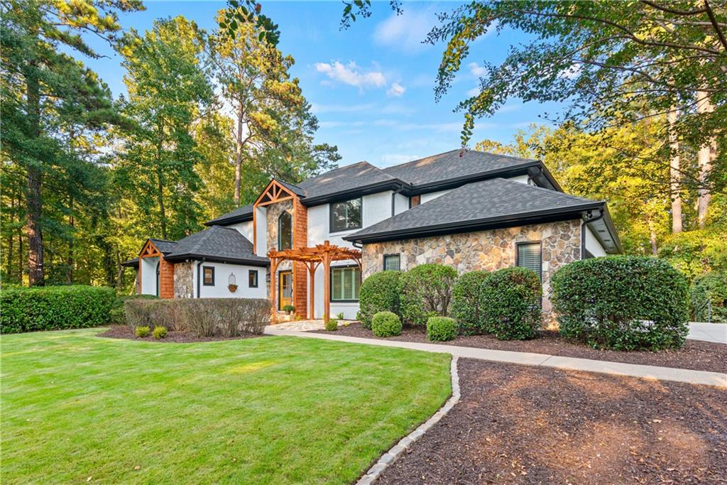 Nestled on an oversized private corner lot in the prestigious Estates section of Horseshoe Bend, this fully renovated home has been transformed from top to bottom. Every major surface and system has been updated, making it truly move-in ready.
The heart of the home is a stunning open-concept kitchen with brand-new Z-Line appliances, flowing seamlessly into the spacious great room, dining area, and sunny breakfast nook. An oversized mudroom with a drop zone and a full laundry room add function and convenience, while a screened porch with fireplace and an outdoor kitchen extend the living space for year-round entertaining.
The luxurious owner’s suite offers a spa-inspired bath, sitting area with fireplace, walkout to the deck, and three oversized closets. Upstairs, three spacious bedrooms provide flexibility, while the newly expanded terrace level includes two bedroom suites, a large full bath, media room, glass-enclosed wine closet, and abundant storage.
Step outside to your private backyard oasis featuring a heated pool and spa with two cascading waterfalls and three soothing bubblers on the tanning ledge, plus a fire pit, putting green, and fenced yard. New gutters, roof, and windows complement designer finishes throughout, blending timeless elegance with modern luxury—perfect for today’s lifestyle.