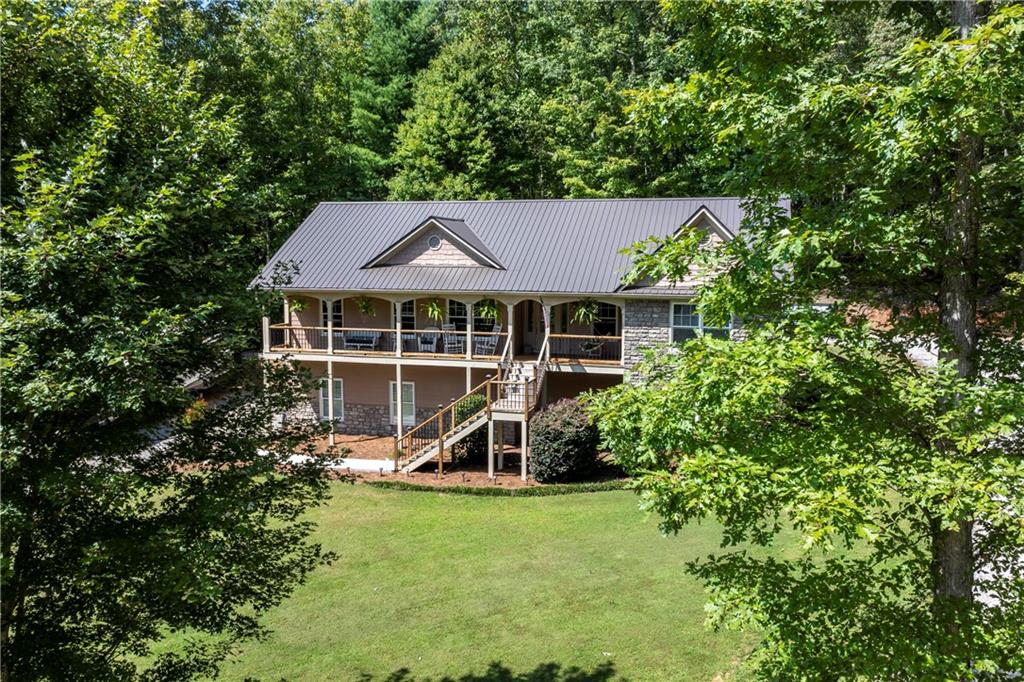 Welcome to this custom-built ranch home nestled on 5 serene mountain acres. Thoughtfully maintained, this property features a new metal roof, new deck, and a recent water heater, ensuring peace of mind for years to come. Car enthusiasts and hobbyists will appreciate the 30x30 oversized garage along with a 40x60x12 shop complete with two 10x10 roll-up doors, two walk-in doors, power, water, and plumbing stubbed for a half bath. The home invites you in with a rocking chair front porch and a spacious family room highlighted by a stone fireplace with newly installed ventless gas logs. The kitchen boasts maple cabinetry, granite counters and maple hardwood floors that flow throughout the main living areas. A generous laundry room on the main level provides ample cabinet space for storage. The oversized owner’s suite on the main features a double trey ceiling, walk-in closets, and a relaxing bath with double vanity, soaking tub, and separate shower. Secondary bedrooms also include walk-in closets and share a convenient Jack & Jill bath. The finished basement offers a private office—perfect for working from home. Designed with ease of living in mind, the property includes dual driveways: one leading to basement access and the other to the kitchen entry with just two steps. The location is less than 3 miles to downtown Jasper and feels a world away!
This home combines modern updates, functional spaces, and mountain tranquility—perfect for full-time living or a weekend retreat.