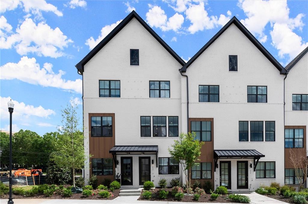 Our Model home is officially Open!! You won't want to miss our Spring Savings!!!! Welcome to The Anniston at The Gathering, a stunning Contemporary style townhome designed for modern living. This beautifully crafted home offers 1,644 square feet of thoughtfully designed space, features two bedrooms, a flex space, and three luxurious bathrooms, perfectly blending comfort and style. As you enter the Anniston you will find a versatile terrace level that includes a cozy flex space, a full bathroom, and convenient access to the garage. Ascend to the main living area on the second floor, where 10-foot ceilings and an open-concept layout seamlessly integrates the kitchen, dining area and living room. The gourmet kitchen showcases quartz countertops, KitchenAid appliances and maple cabinetry. This space is perfect for entertaining guests or enjoying a quiet evening at home. Step out onto the covered deck off the living area to enjoy fresh air and outdoor relaxation. The third floor is dedicated to restful retreats. The primary suite boasts a walk-in closet and a well-appointed bathroom featuring double vanities, quartz countertops and a glass shower providing a serene sanctuary. A second bedroom, complete with its own full bath, offers comfort and privacy for family members or guests. The Gathering is a vibrant new community, just minutes from downtown Alpharetta, Avalon and top-rated schools. Walk out your front door and hop right on the popular Alpha Loop. Enjoy our community amenities such as a Community Garden, Firepit and Dog Park. This home provides the ultimate modern suburban living. Experience the perfect combination of style, comfort and convenience!! This home is MOVE-IN READY!! Agent is on-site Monday, Tuesday & Saturday (10:00-6:00) and Wednesday and Sunday (1:00-6:00). Photos are a representation of floorplan, not actual unit, design selections may vary.