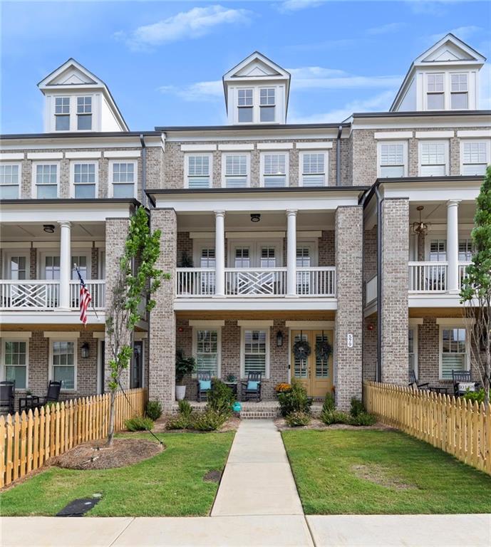 Like-new Andover floorplan townhome located in the highly desirable South on Main community, just a short stroll from vibrant Downtown Woodstock. Less than a year old, this stunning home features numerous upgrades made during construction, with additional enhancements added afterward for modern luxury and convenience. Spanning three levels, the home includes an oversized rear-entry garage with epoxy floors, double-depth space ideal for a golf cart, and a 220V EV charger for fast vehicle charging. The terrace level offers a practical drop zone with bench seating and a private bedroom with a full bath, perfect for guests, a home office, or flex space. The main level is thoughtfully designed for comfort and entertaining, boasting a spacious family room with a gas fireplace flanked by custom-built-ins. The separate dining area includes a beautiful bar that currently serves as a cozy sitting space, flowing seamlessly into the heart of the home—a chef’s kitchen outfitted with a large island with seating, ample cabinetry and counter space, stainless steel appliances, and a walk-in pantry. A casual breakfast area and additional seating nook add functionality and charm, while the rear covered porch provides a private outdoor retreat ideal for grilling and relaxing. A convenient half bath completes this level. Upstairs, the luxurious owner’s retreat offers a tranquil sitting area and access to a private covered porch—perfect for enjoying morning coffee. The ensuite bath features double vanities, a soaking tub, a spacious walk-in shower, and two large walk-in closets. A secondary bedroom also includes a private bath and walk-in closet, offering both space and privacy. The upper level also includes a well-appointed laundry room complete with a laundry sink, built-in storage, and washer and dryer. South on Main is one of Woodstock’s premier communities, offering 20 acres of green space and parks, a community garden, firepit, resort-style swimming pool with kids’ splash pad and cabana, and a 6,000-square-foot clubhouse with fitness center, game room, and conference space. Additional amenities include two dog parks, a play park, an open-air pavilion, “The SHED” and a stage for events, and direct access to the Noonday Creek Trail, part of the expansive Greenprints Trail System. All of this is just steps from the shopping, dining, and entertainment of Downtown Woodstock and minutes to I-575 for an easy commute to Atlanta and beyond. Discover why South on Main and Woodstock continue to be among North Georgia’s most sought-after destinations.