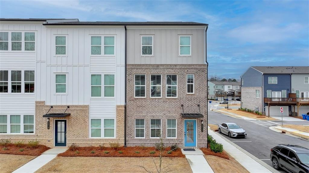 This exquisite three-level townhome, nestled within the desirable Lawrenceville, Georgia community of The Beacon at Old Peachtree, offers an ideal location that balances convenience and lifestyle. Featuring an open floor plan and contemporary design, the home seamlessly blends style with functionality. The main level boasts a spacious kitchen equipped with a large island, perfect for both everyday living and entertaining. Its generous layout allows for effortless gatherings with family and friends, whether sharing meals or celebrating special moments. The adjacent family room, highlighted by a cozy fireplace, offers a warm and inviting atmosphere, while the expansive deck provides the perfect outdoor retreat to enjoy the sunshine. On the upper level, two well-proportioned bedrooms share a full hallway bath, while the private primary suite serves as a serene retreat. This luxurious space includes a large walk-in closet and an en-suite bathroom, providing a peaceful sanctuary at the end of each day. For added convenience, the laundry room is located on the same level as the bedrooms. The lower-level recreation room offers versatile space that can easily be tailored to suit various needs, whether as a private office, additional family room, or playroom. Outside your door, there’s an abundance of opportunities to explore. Spend a day shopping at the nearby Mall of Georgia, catch a game at Coolray Field, or enjoy weekends at local parks or golf courses. The Beacon at Old Peachtree also provides easy access to commuter routes, making both daily commutes and weekend trips effortless. Residents enjoy an active lifestyle with on-site amenities including pickle-ball and tennis courts, a walking path, and parks. With complimentary lawn maintenance, you’ll have more time to relax by the neighborhood pool and cabana. Additionally, the townhome is part of a highly regarded school district, offering access to some of the best schools in Gwinnett County.