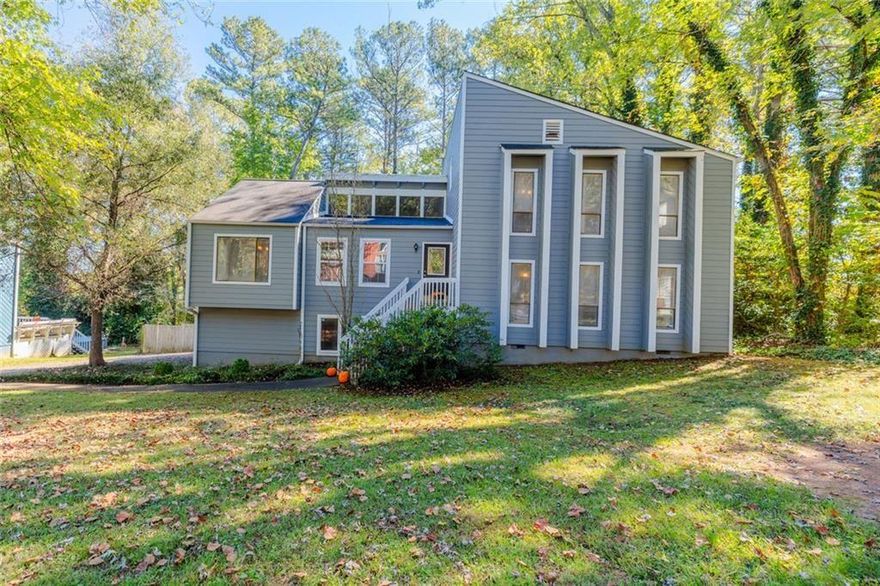 You will fall in love with this beautifully updated contemporary home sited in a walkable, convenient East Cobb neighborhood. The interior boasts stunning trim work and architectural design including a soaring vaulted family room with natural wood beams and a cozy fireplace for relaxing on cool fall nights. The family room opens to the dining room area leading to the updated kitchen with stainless steel appliances, breakfast bar, sleek granite countertops and tiled backsplash. Lush hardwood floors carry throughout much of the home. On the upper level you find the spacious owner’s suite with updated ensuite bath. Two additional spacious bedrooms and full bath are found on the upper level. Transcending to the lower level provides a fabulous space for teen hang out or private guest quarters, offering a spacious gathering room and very large bedroom another ensuite bath. Outdoor entertaining is a breeze with two large decks and flat backyard with wooded perimeter for added privacy. The home offers a 2-car garage and lots of storage space! The property is located in a prime Marietta neighborhood near excellent schools, dining, parks, shopping and more!