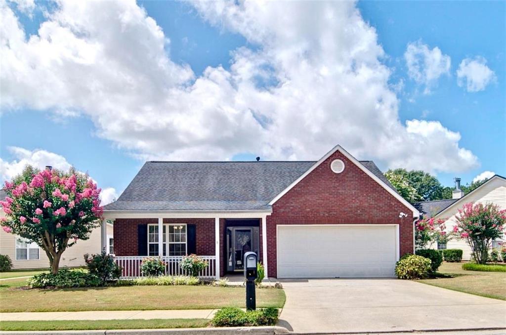Charming Brick-Front Ranch in 55+ Community! Welcome home to this beautifully maintained 2 bedroom, 2 bath ranch, nestled in a sought-after 55+ community. With a stepless foyer entry and desirable split bedroom floor plan, this home offers comfort, convenience, and privacy. Step into a spacious family room with vaulted ceilings and an abundance of natural light. The white, bright kitchen features plentiful cabinetry, a breakfast bar, and a stylish tiled backsplash - perfect for both casual dining and entertaining. A separate laundry room adds everyday ease. The oversized owner's suite boasts a large walk-in closet and a tiled ensuite bath. The secondary bedroom and full bath are thoughtfully located on the opposite side of the home, ideal for guests or a home office. Enjoy fresh air on the covered front porch or relax in the backyard overlooking the peaceful community gazebo and courtyard. You'll also love the mature, vibrant landscaping, blueberry bushes, and colorful flowers that surround the home. Additional highlights include brand new LVP flooring, tile flooring in both bathrooms, and a spacious 2-car garage with extra storage. This move-in ready gem offers low maintenance living in a friendly, well-kept community - don't miss your chance to make it yours!