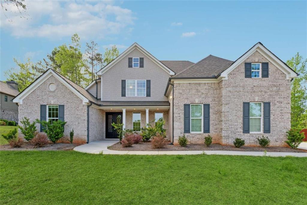 Special Financing Available! Lock in a fixed 4.99% interest rate with preferred lenders or receive up to $15,000 in builder incentives, plus additional savings through our preferred lender network. The Hedgegrow III Plan offers 4 bedrooms, 3.5 baths, and a spacious bonus room that can function as a 5th bedroom, media room, or office. Hardwood floors flow from the foyer into the dining area and a two-story family room with a gas fireplace. The gourmet kitchen features solid stone countertops, 42-inch cabinets, and stainless steel appliances. The main-level primary suite includes vaulted ceilings with double fans, hardwood flooring, a spa-style bath, and a large walk-in closet. Upstairs you'll find three bedrooms, two full baths, and a flexible bonus room. Enjoy the covered patio overlooking the backyard, ideal for entertaining or relaxing. The home also includes a three-sided brick exterior for lasting curb appeal. Located in a swim and tennis community with clubhouse and playground, just 20 minutes from I-20 with easy access to Atlanta, shopping, and the airport. Hadi Builders is a custom homebuilder. Pick your lot and create your dream home. Additional lots and plans available, or bring your own for approval.