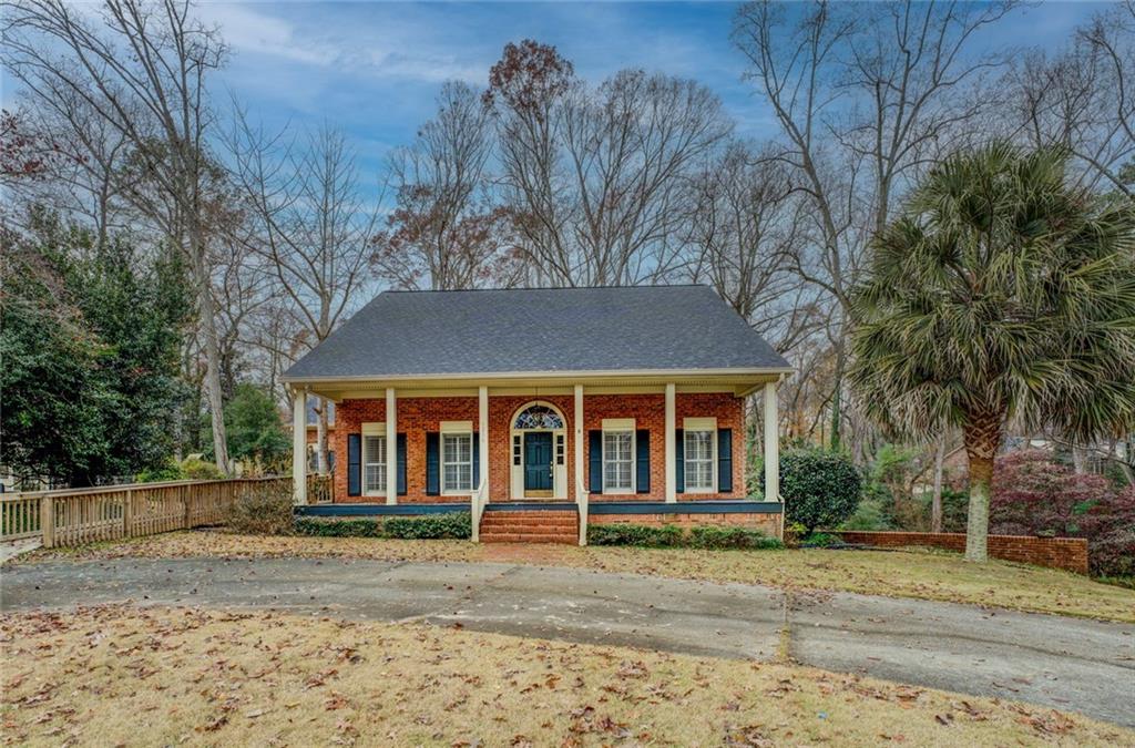 Custom Built all brick home on large lot. Architect designed this beauty. Heart pine floors throughout main level which came from a 150 year old factory. 10' soaring ceilings throughout . Solid oak cabinets. Formal separate dining room, living room, Light and bright breakfast room, Den with masonry fireplace and oak mantel, sunroom overlooking private backyard, Master on main with his and hers walk in closets, Double vanities, jetted tub and separate shower. Upstairs you will find 3 very large bedrooms with their own vanities and sink. Extra large bonus room/office and full bath. Basement has a finished room and drive under double car garage. Extra storage under the sunroom with concrete floor and shelving. Landscaping (with some TLC) has stoned walking paths across a wooden bridge. 25 camelia bushes, palm trees, ferns etc. New roof. Close to Old Town Conyers, shopping, restaurants and interstate. Well established neighborhood.
