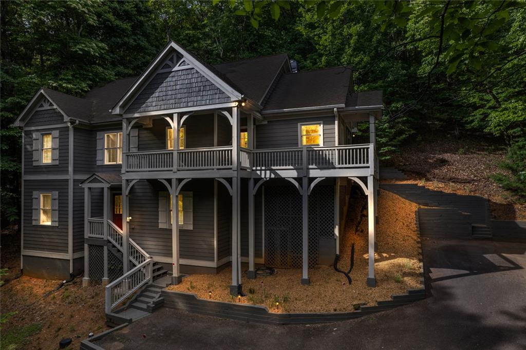 Tucked away in the tranquil woods of Big Canoe, this 1846sf gem offers a tranquil retreat from the bustle of everyday life. As you approach, the sounds of a gentle cascading creek welcome you, setting the tone for the serenity that awaits. Step inside to find a spacious open-plan living area, where 11" wide plank wood floors and floor-to-ceiling windows frame lush forest views. A stacked stone fireplace adds charm and warmth. The heart of this home is its expansive kitchen, brimming with cabinet and counter space, perfect for culinary adventures. A cozy breakfast bar and an inviting dining area make every meal special. Venture outside to the screened porch or stone patio, where you can immerse yourself in the beauty of nature and cool breezes. Upstairs on the main floor, the primary suite offers a peaceful haven with a spacious bathroom and walk-in closet. The thoughtful layout continues to the lower level, featuring two additional bedrooms, a full bath, and a private entrance, ideal for guests or family. Just minutes from Big Canoe’s amenities and a short drive from the north gate, this home is a harmonious blend of seclusion and convenience. Here, every day feels like a retreat, surrounded by nature’s beauty and the comfort of a truly charming home.