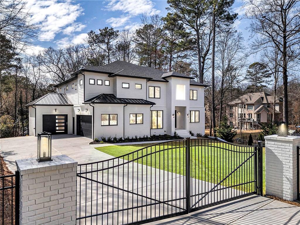 Solid-built gated estate on over half an acre, conveniently located near shopping, restaurants, downtown Roswell, and major highways (400 & 285). This modern, custom-built home offers 6 bedrooms, 6 full baths, 2 half baths, and a 3-car garage—perfect for multi-generational living. Every bedroom includes a private bath with a frameless glass walk-in shower, a walk-in closet, and a separate thermostat, ensuring comfort and privacy for all.
Designed with the most functional floor plan in mind, the home features a dramatic two-story foyer, airy 12’ ceiling in the great room, and abundant natural light from large custom windows. Stackable sliding doors seamlessly blend indoor and outdoor living, leading to a spacious covered back deck with Trex flooring and sleek metal handrails.
The high-end gourmet kitchen boasts an oversized island with waterfall quartz countertops, Thermador appliances, custom double-stacked cabinetry, and a walk-in pantry—offering both beauty and utility. Hardwood floors throughout the home provide a clean, allergen-free living environment.
A main-level guest suite is ideal for in-laws. Upstairs, you'll find four additional bedrooms with tray ceilings, four baths, and a large media room. The owner’s suite showcases a timeless design with a luxurious bathroom, floor-to-ceiling glass super shower, dual water closets, and spacious his-and-hers walk-in closets with built-in shelves.
The finished daylight terrace level features a second full kitchen—ideal for an in-law or teen suite—a movie theater, and a bedroom with ensuite bath. The private, fenced backyard offers ample space for a pool, outdoor kitchen, and more.
Energy-efficient touches such as spray foam insulation and a tankless water heater help lower utility bills. Located in the desirable Willow Point subdivision, amenities include a swimming pool, tennis courts, playground, basketball court, and pavilion. With a long driveway providing ample guest parking, this North-facing, move-in-ready home is a rare combination of timeless design and modern luxury.
