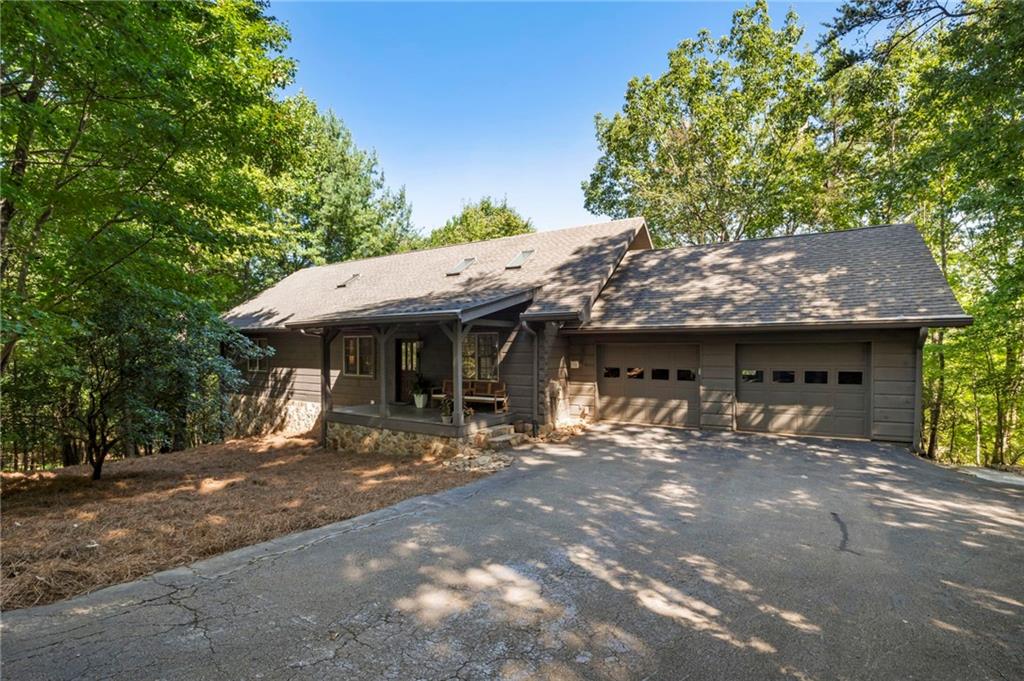 This stunning mountain retreat is nestled on a quiet, wooded lot in the desirable southern section of Big Canoe with seasonal mountain views and bordering the golf course. This beautifully maintained 4-bedroom, 3-bath ranch home offers main-level living at its finest, along with a fully finished terrace level and exceptional privacy. Inside, you’ll find an open and airy floor plan accented by hardwood floors, a stacked stone fireplace, and designer finishes throughout. The kitchen has beautiful granite countertops, abundant cabinetry, and modern appliances. The spacious primary suite, conveniently located on the main level, includes an updated en-suite bath and generous closet space. The terrace level expands your living options with a large recreation/media room, a kitchenette, a flex room suitable for a home office, and a second laundry area. Outdoor living is equally inviting, featuring a large, screened porch that is perfect for relaxing in the peaceful natural surroundings and taking in the seasonal mountain views. Set back from the street for ultimate privacy, this home is ideally located near community amenities and close to the back gate for easy access.
**A mandatory $4,500.00 capital contribution fee paid by the purchaser to the Big Canoe Property Owners’ Association will be due at closing. **Pursuant to Article II, Section 1, Paragraph bb of the Class “A” Covenants for the Big Canoe community, all property transfers are subject to the Big Canoe developer’s right of first refusal.