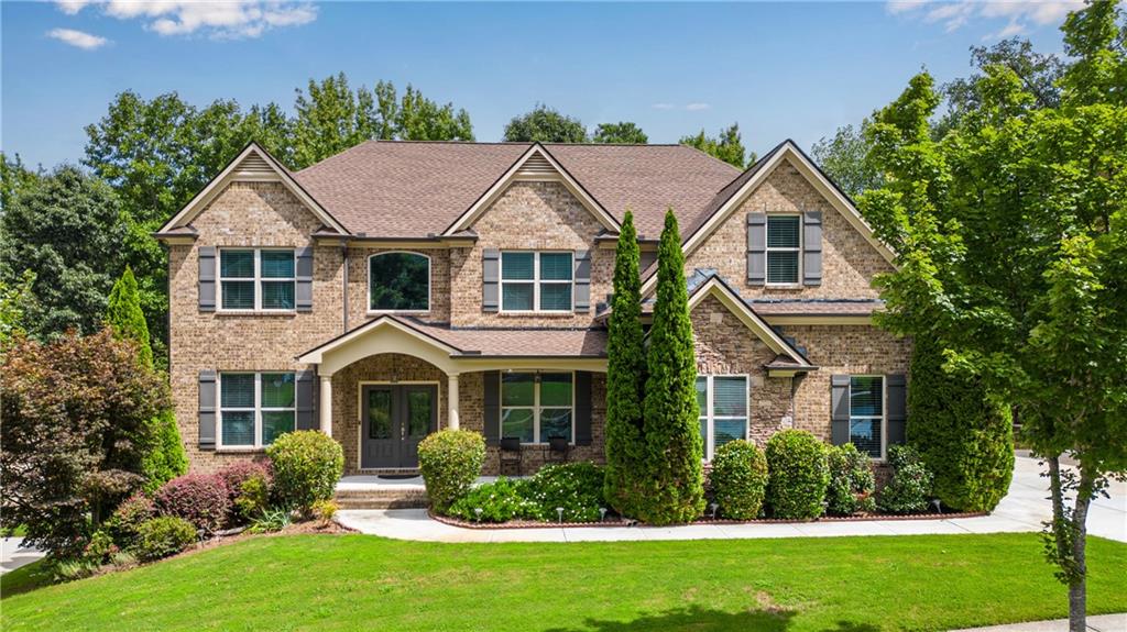 Executive home on seasonal Lakeview Lot! 3-sides brick & stone, 3-car garage + full daylight basement for future expansion! The rocking chair front porch opens the double entry door foyer boasting hardwood floors that span the entire main level all the way into the main level guest bedroom. Formal LR or Study. Formal dining. Dramatic two-story fireside great room views the island kitchen w/gas cooking. Hardwood staircase leads the upper balcony/halls with NEW flooring. Spacious primary suite w/double tray ceiling leads the bath w/oversized tile shower, jetted tub and Juliet balcony overlooking the lake. HUGE primary closet has lots of potential for future custom closet. Two bedrooms share a jack & jill bath. 5th bedroom has a private bath and HUGE 10 x 9 walk-in closet with window. Upstairs laundry. NEW deck overlooks lake! Additional patio off the terrace level. Swim/Tennis/Playground Community in the coveted Brookwood High School District.