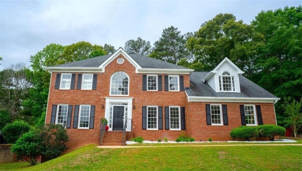 Welcome to this stunning, move-in ready home in the desirable Sentinel West subdivision of Marietta, perfectly situated on nearly half an acre, on a full basement, and just steps away from the community amenities, including a pool and tennis courts. With summer just around the corner, now is the perfect time to enjoy everything this property has to offer. Boasting a classic brick front, established landscaping, a two-car side-entry garage, and an inviting front stoop, this home impresses from the start. Inside, a soaring two-story foyer leads to a formal dining room with elegant wainscoting, a formal living room, and a spacious family room featuring a wood-burning fireplace and French doors that open to a bright, airy sunroom. The sunroom overlooks the expansive, fenced-in backyard with wooded views and no rear neighbors for a private retreat you can utilize year around. The oversized eat-in kitchen is the heart of the home, complete with granite countertops, high-end stainless steel appliances, a wine rack, large island that seats up to six, and a stunning floor-to-ceiling Palladium window that floods the dining area with natural light. Upstairs, you'll find a luxurious primary suite featuring tray ceilings, plantation shutters, spa-like bathroom with split vanities, free-standing soaking tub, large frame-less shower, and a must-see walk-in closet. Three additional generously sized bedrooms and an additional full bathroom complete the upper level. The fully finished basement offers a private entry and covered patio with limitless potential. Ideal for in-law or guest quarters, a young adult apartment, or the ultimate entertainment zone where you'll look forward to hosting friends and family after a day at the pool! Fire up the grill and enjoy the expansive deck, perfect for kicking back and relaxing on your favorite outdoor furniture. With tasteful updates throughout, including modern fixtures and elegant trim work, this home rivals new construction in both style and comfort. Located near recreational facilities, healthcare, shopping, local favorites, lots of grocery options, and the scenic walking trails of Kolb’s Farm, this home combines convenience with a lifestyle of leisure and community. Don’t miss the chance to call this beautiful home yours!